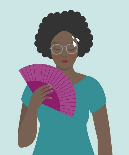 woman fanning herself because of hot flashes