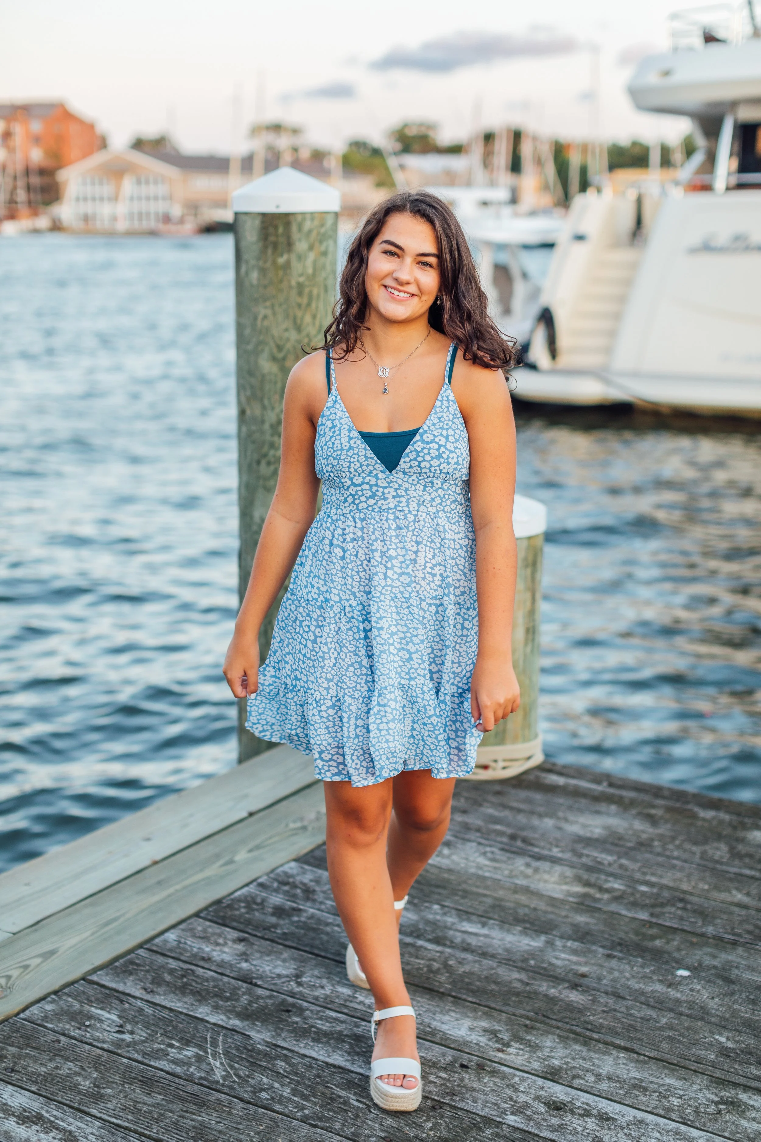 Heidi walking on the dock in Downtown Annapolis during her senior portrait photo session
