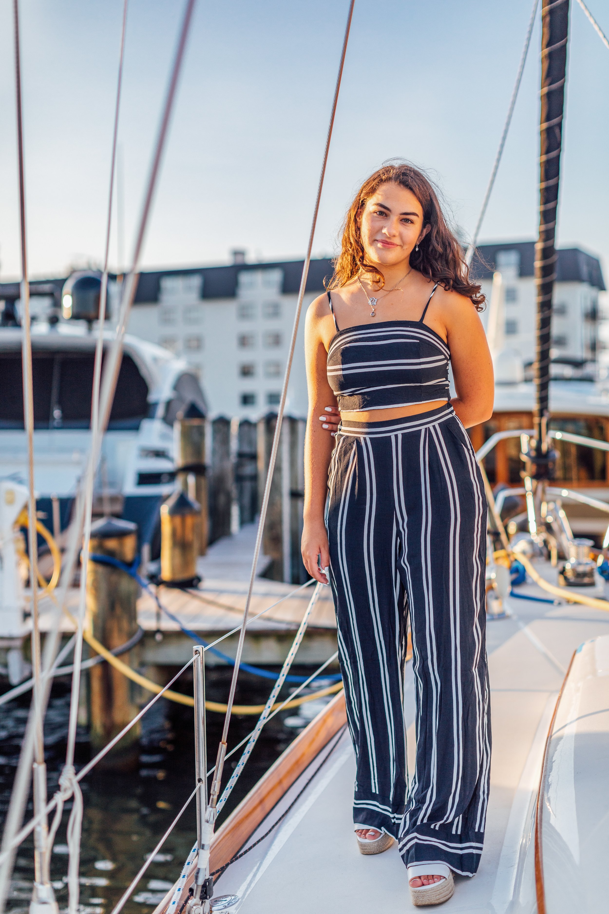 Standing on a boat for her senior portraits in Annapolis Maryland.