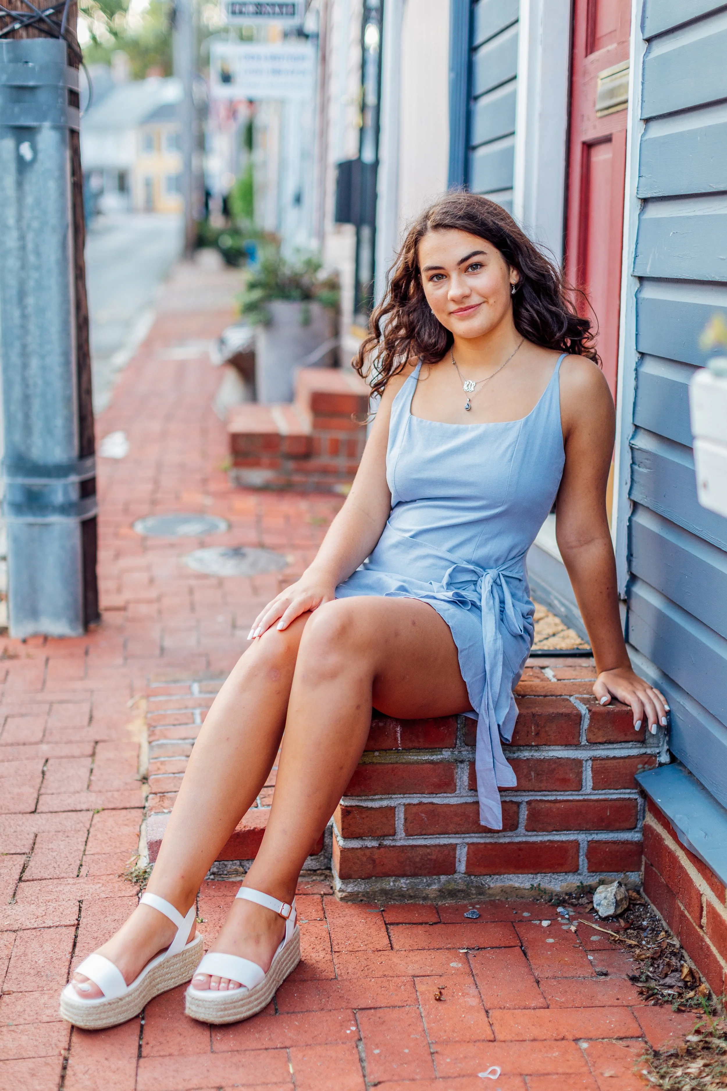 Sitting downtown on a stoop for her Annapolis Senior Portrait session.