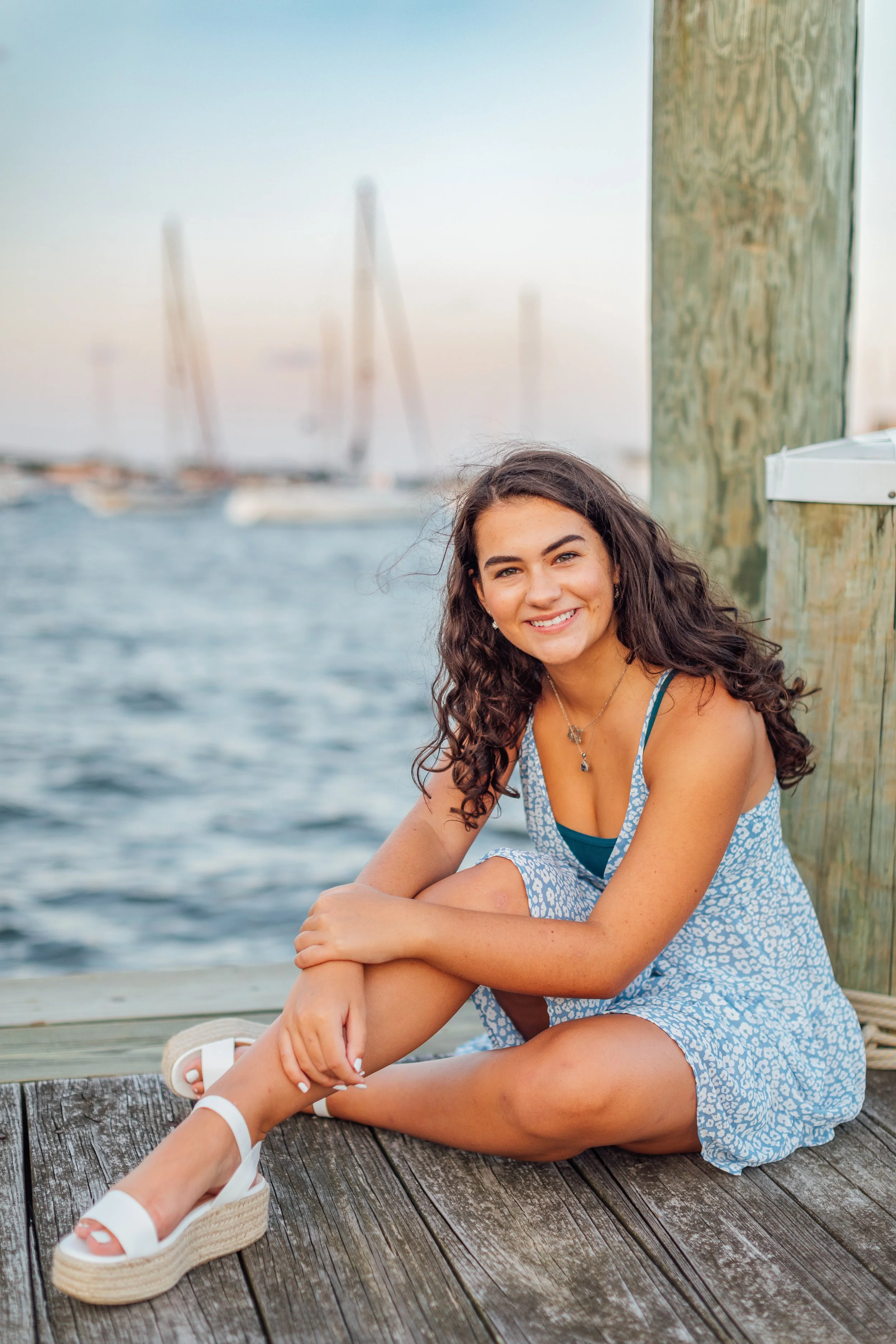 Heidi sitting on the dock in Downtown Annapolis for her senior photos.