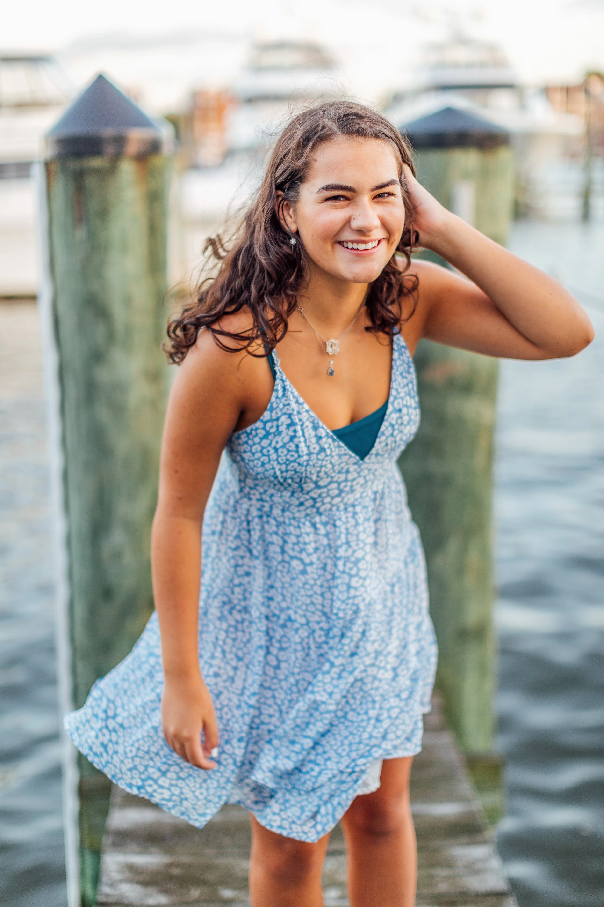 Heidi laughing and smiling on the dock in Downtown Annapolis for her senior pictures
