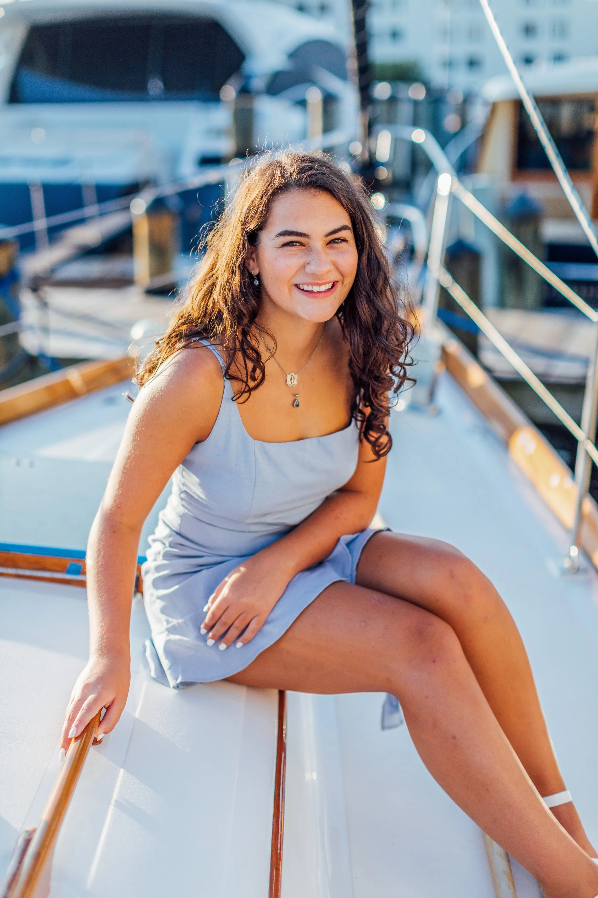 Candid, laughing moment from Heidi's senior portrait session in Annapolis, Maryland on her family's sailboat.