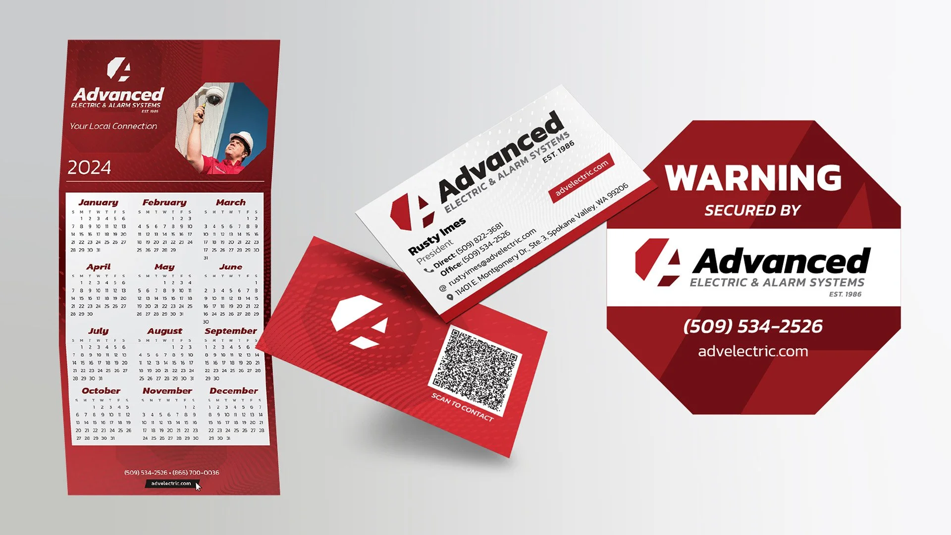 Mockup of various Advanced Electric design projects. Z-fold calendar, business cards, and a warning sign. These all display a consistent modern style with red and digital-looking background texture.