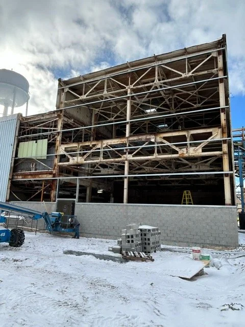 Construction site with a multi-story building framework made of wood and steel