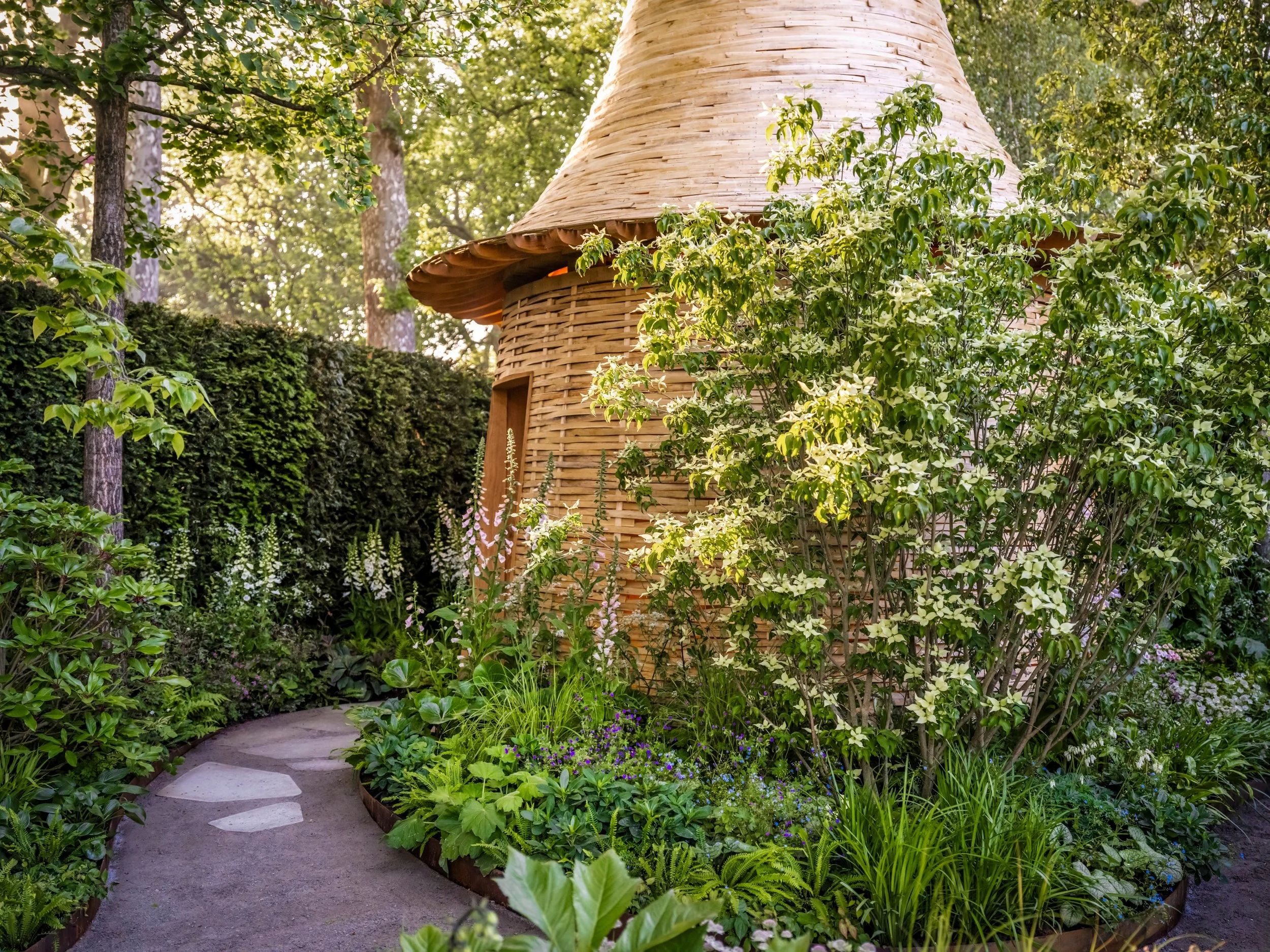 RHS Chelsea Flower Show 2024 St James’s Piccadilly garden by Robert Myers woven timber pavilion with woodland planting