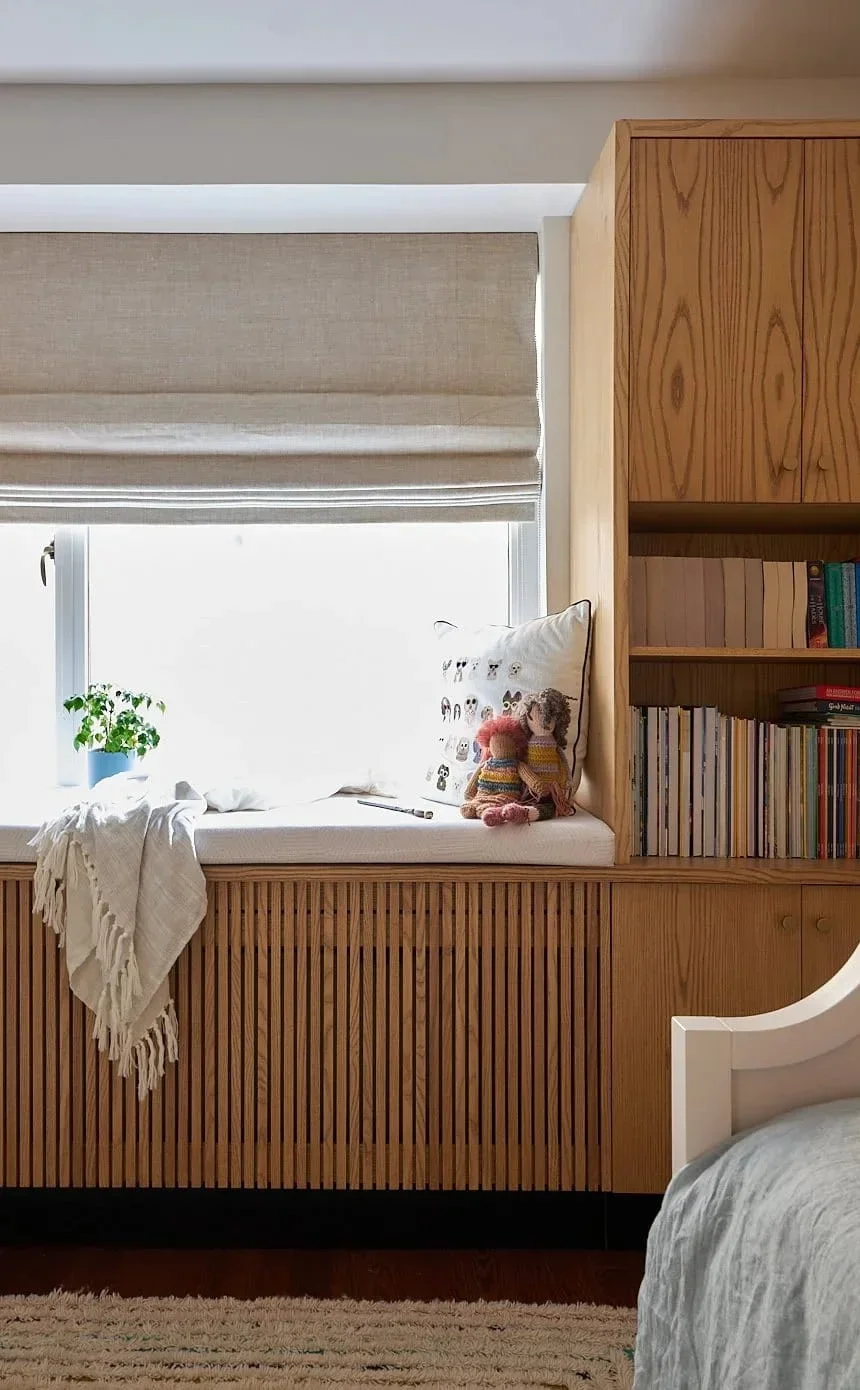 Children's bedroom oak window seat built-in bookshelf.webp