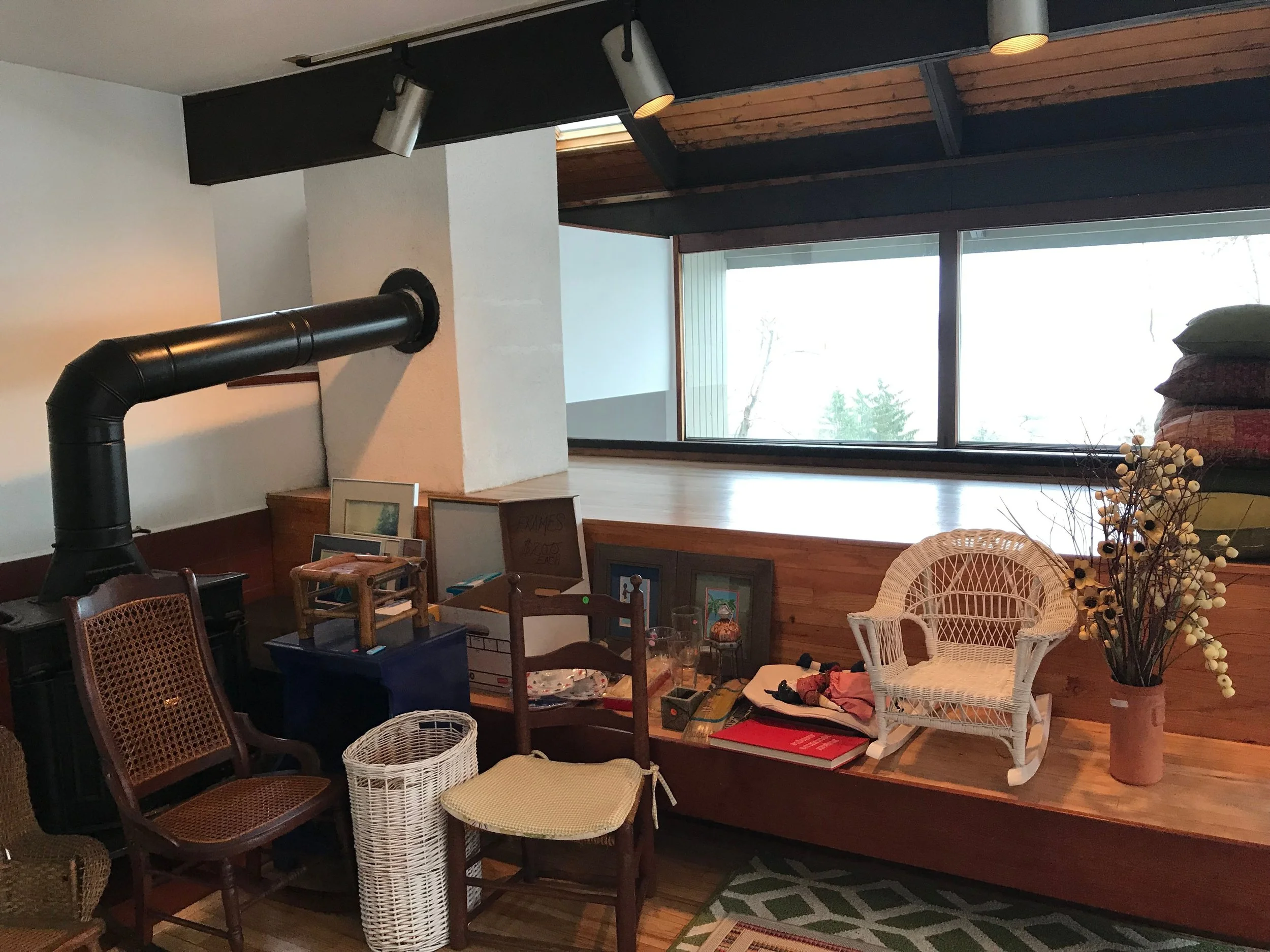 family living room with fireplace and forest views
