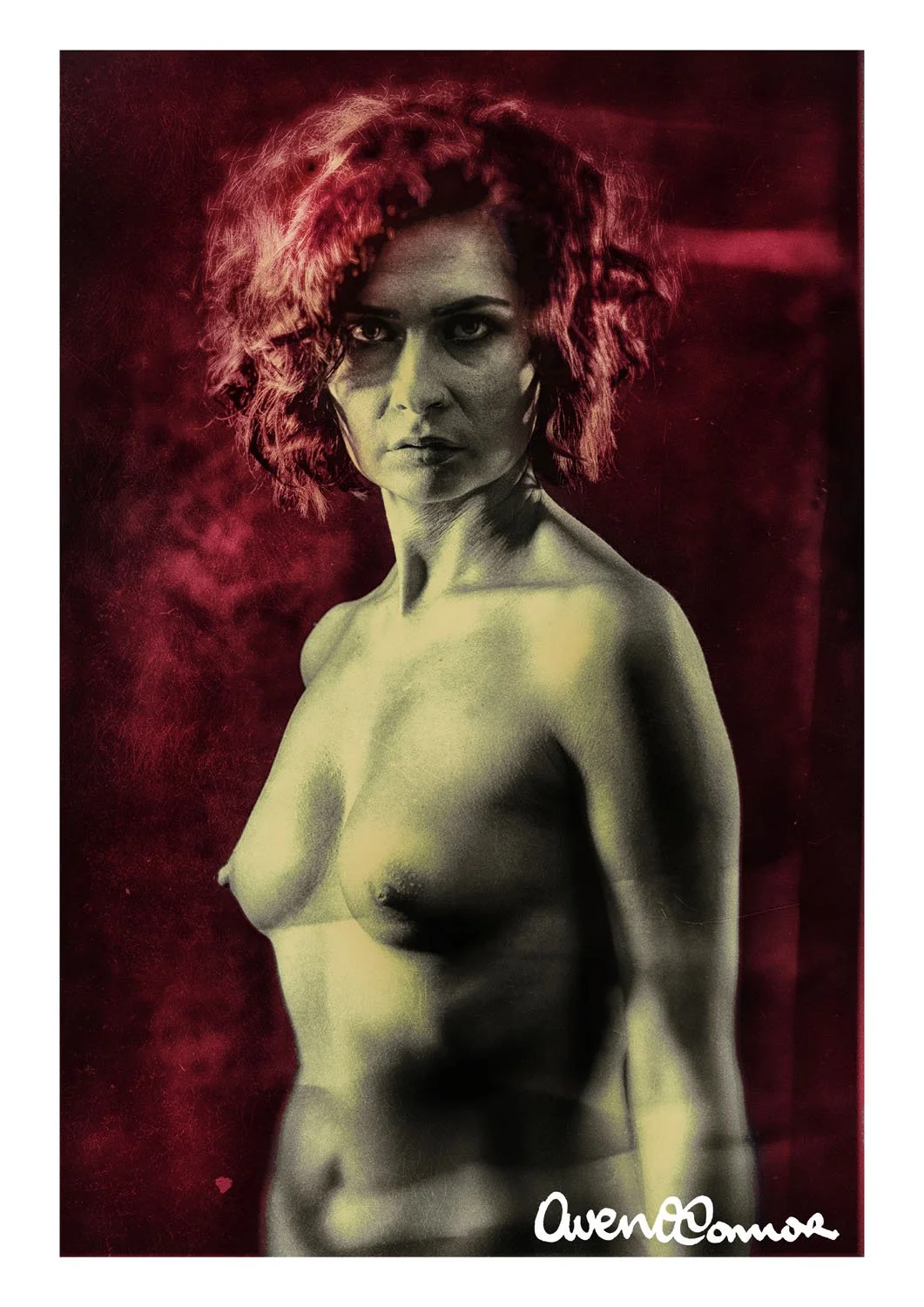 Black and white photo of a topless woman with curly hair, looking at the camera against a dark red background. Text 'Avenue C' and a small heart icon are in the bottom right corner.
