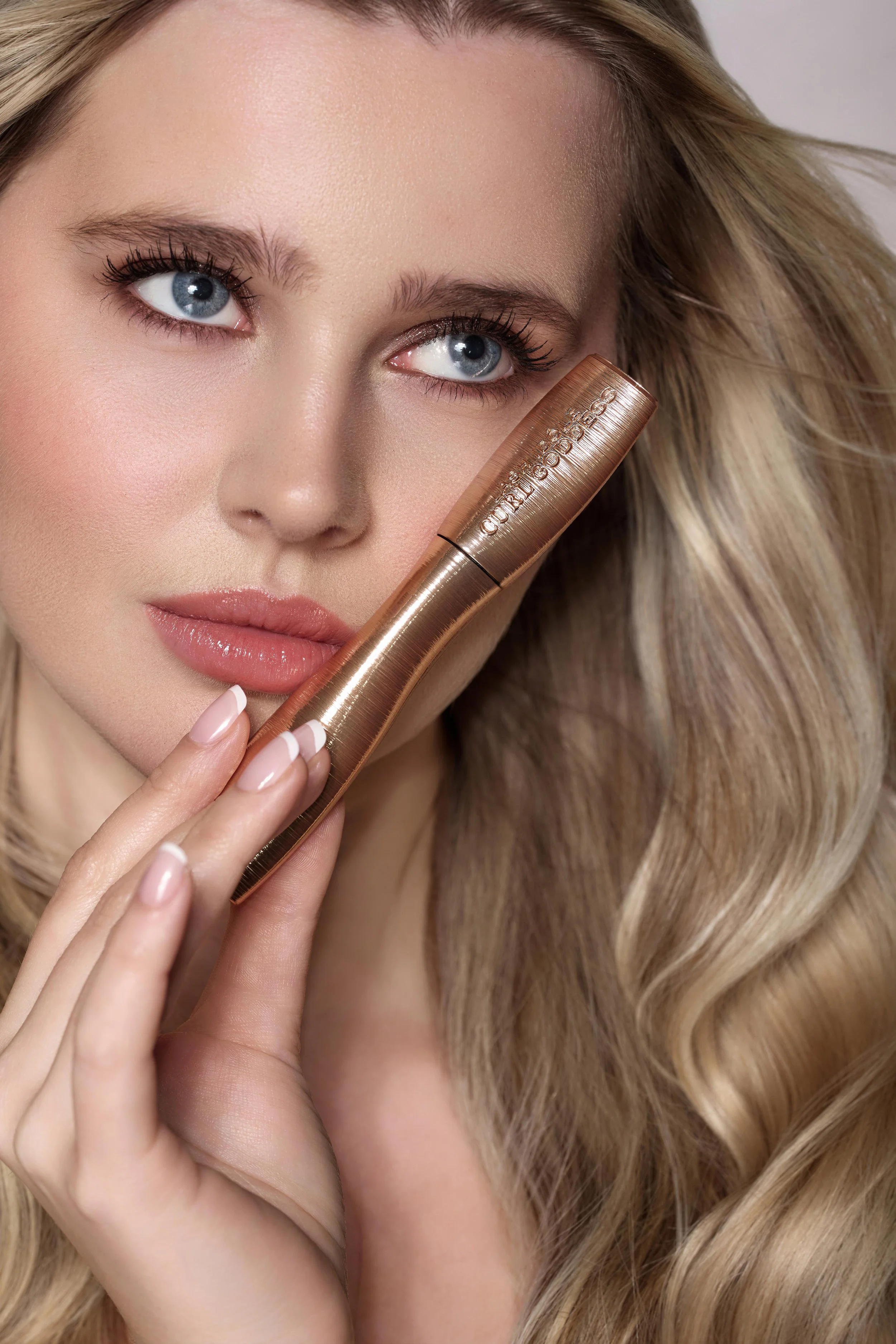 Professional skincare product photography for beauty brands by London photographer Jana Kukebal — model applying cream under soft studio lighting