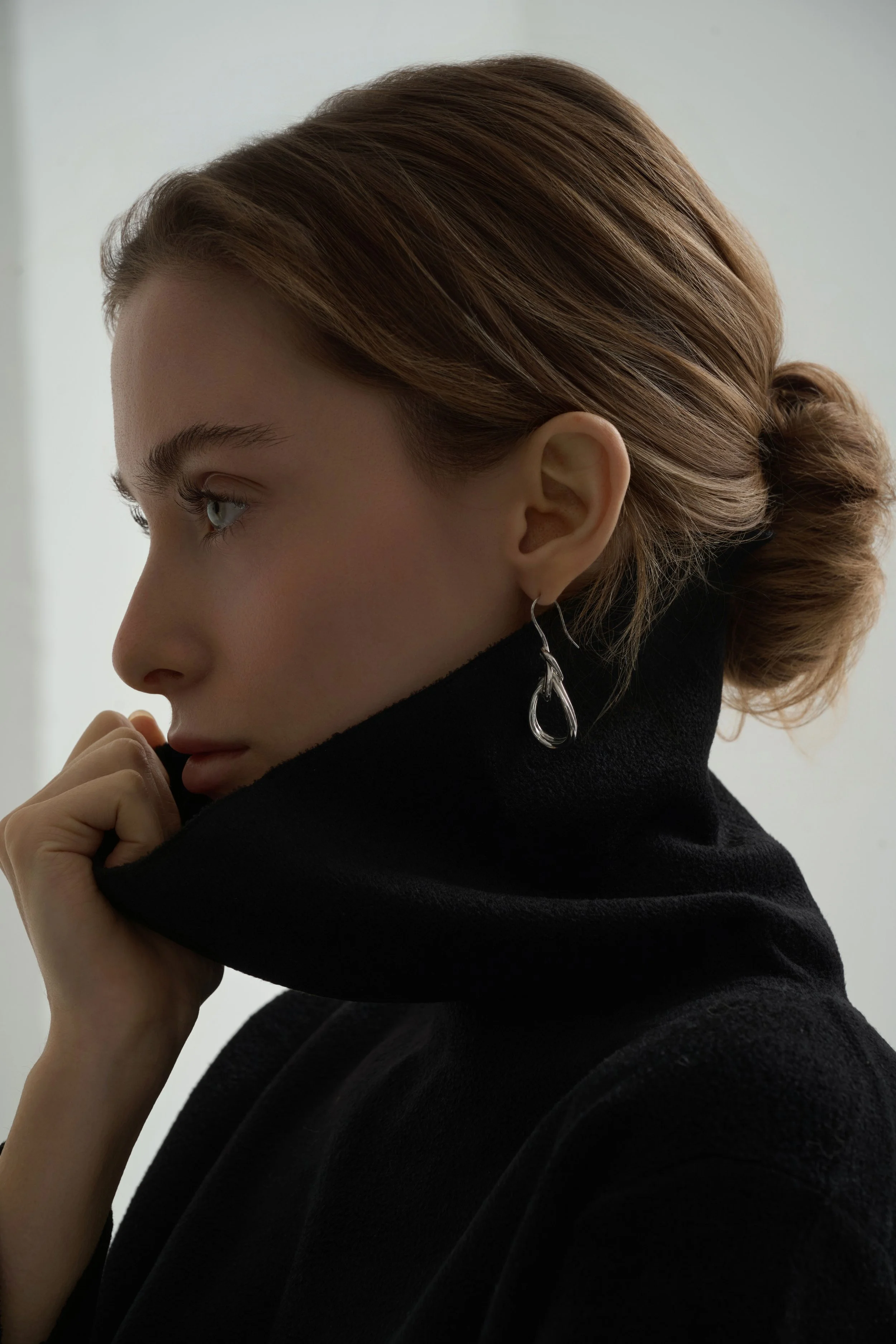 On-model jewellery e-commerce photography highlighting scale and fit of earrings worn on the body