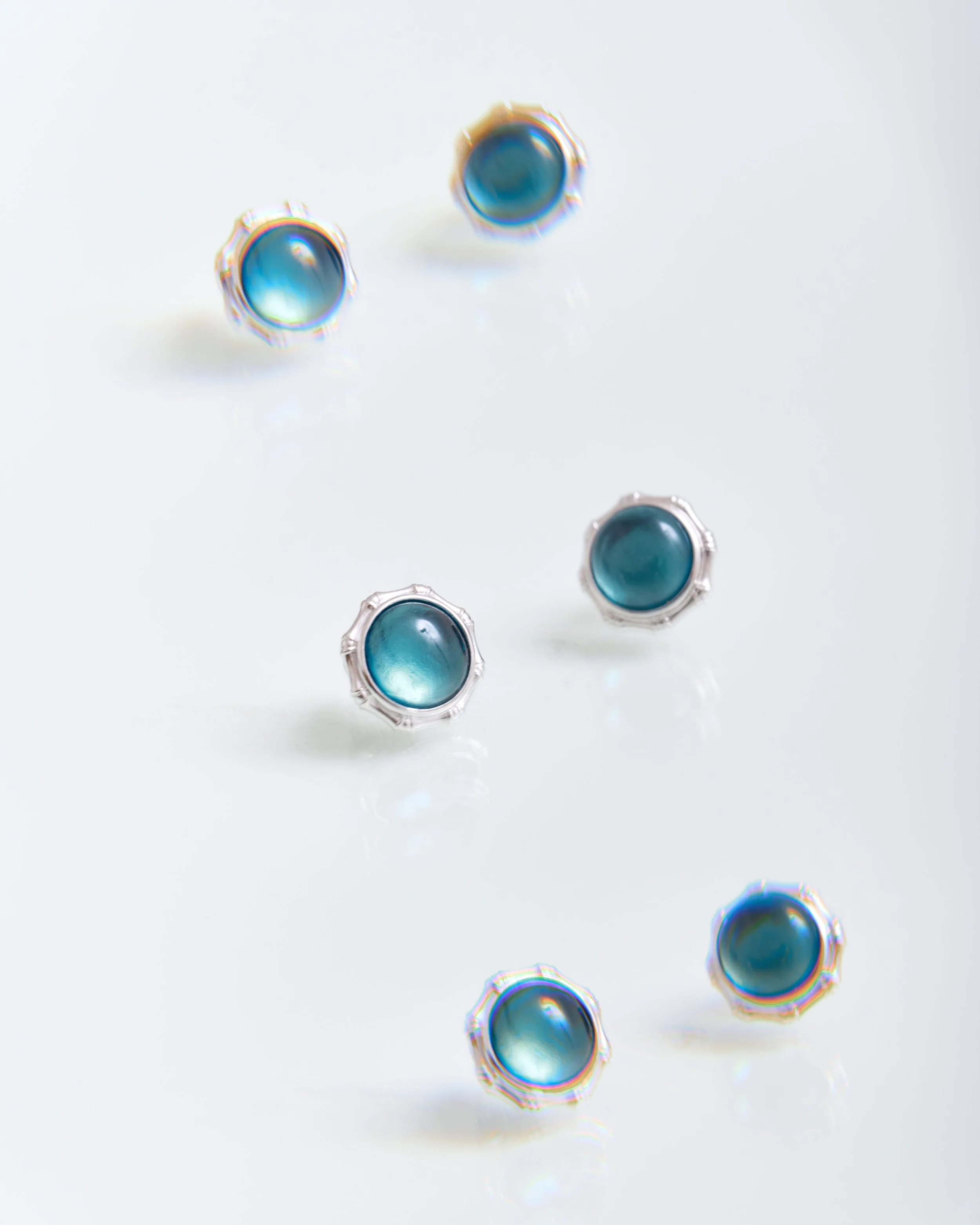 Jewellery product photography of blue stone stud earrings on a clean background for e-commerce websites