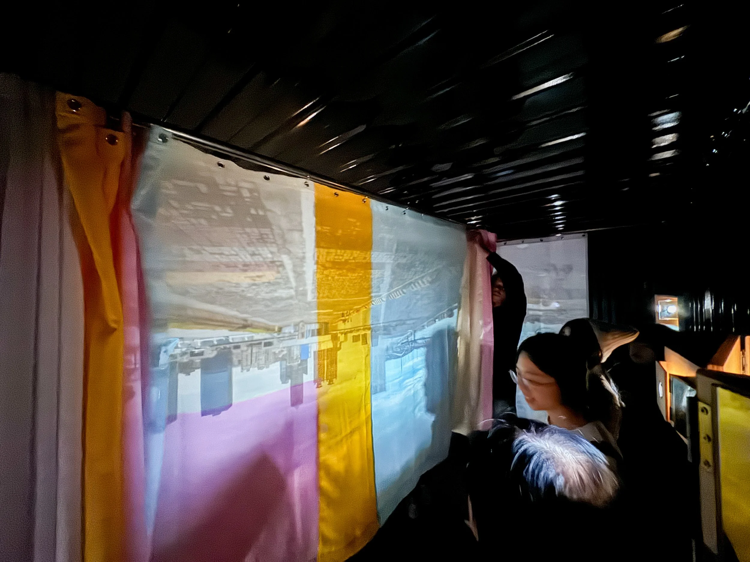 Image Description: Interior view of the Container Camera, where audiences are interacting with the multi colored screen. By Autistic architect and artist, Troels Steenholdt Heiredal