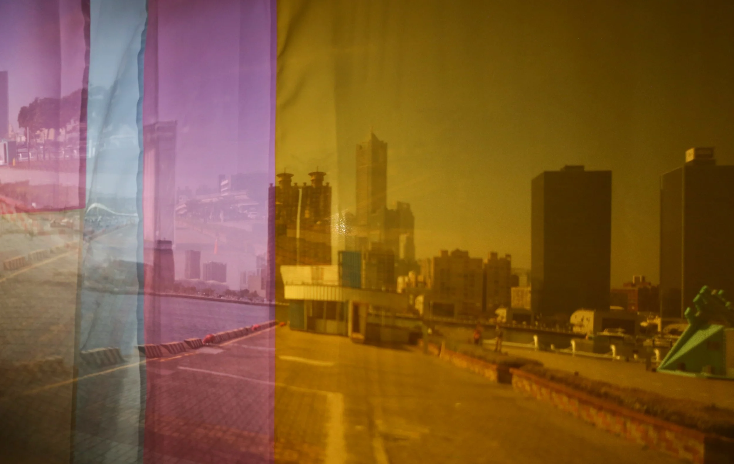 View from inside the Container Camera, a projection of the exterior on a fabric screen with sections of different colors sewn together. The projected scene are from multipel lenses and mixes Kaohsiungs skyline, with the harbour-scape.