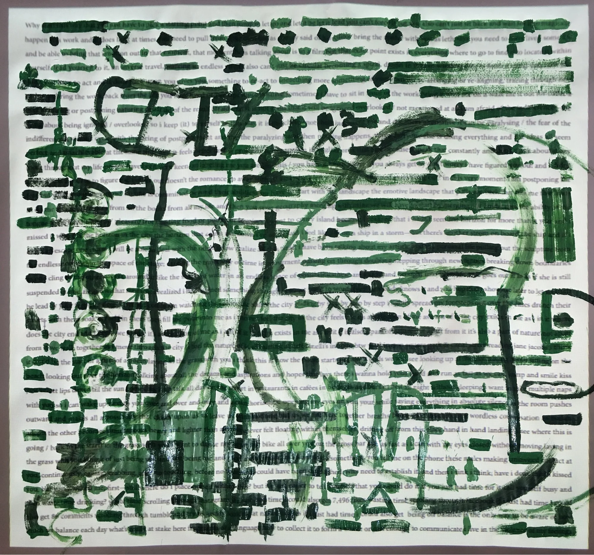 Photo of a poem in a square frame, projected on a large sheet of paper, covered in green paint marks.