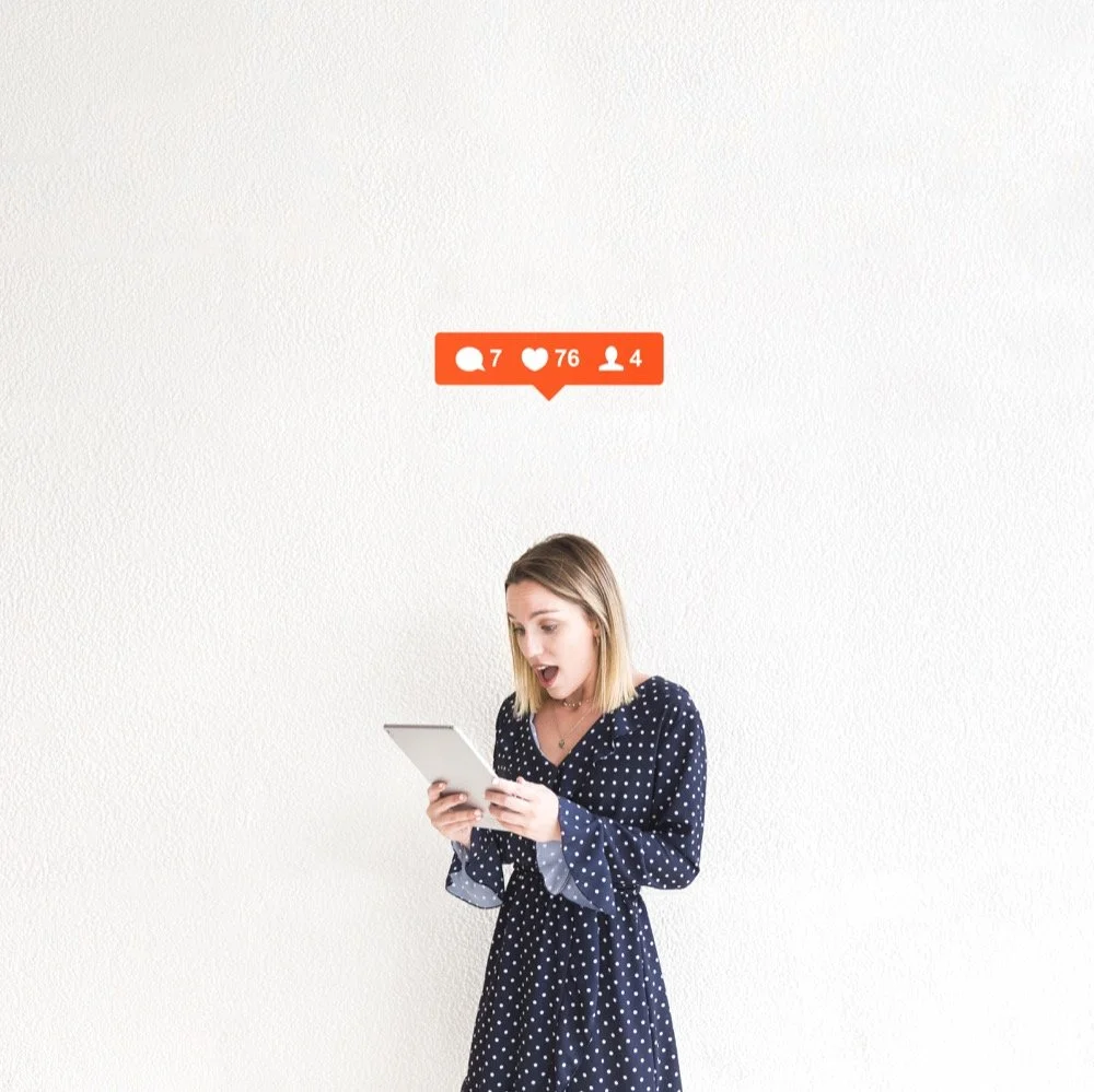 Social media marketing results for small businesses, showing a professional reacting to increased engagement on a tablet, representing Moxie digital marketing.