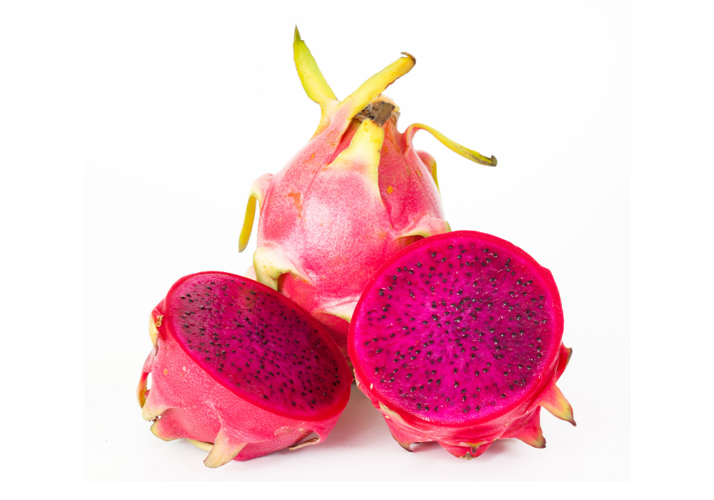 Whole and sliced pink dragon fruit with black seeds on a white background.