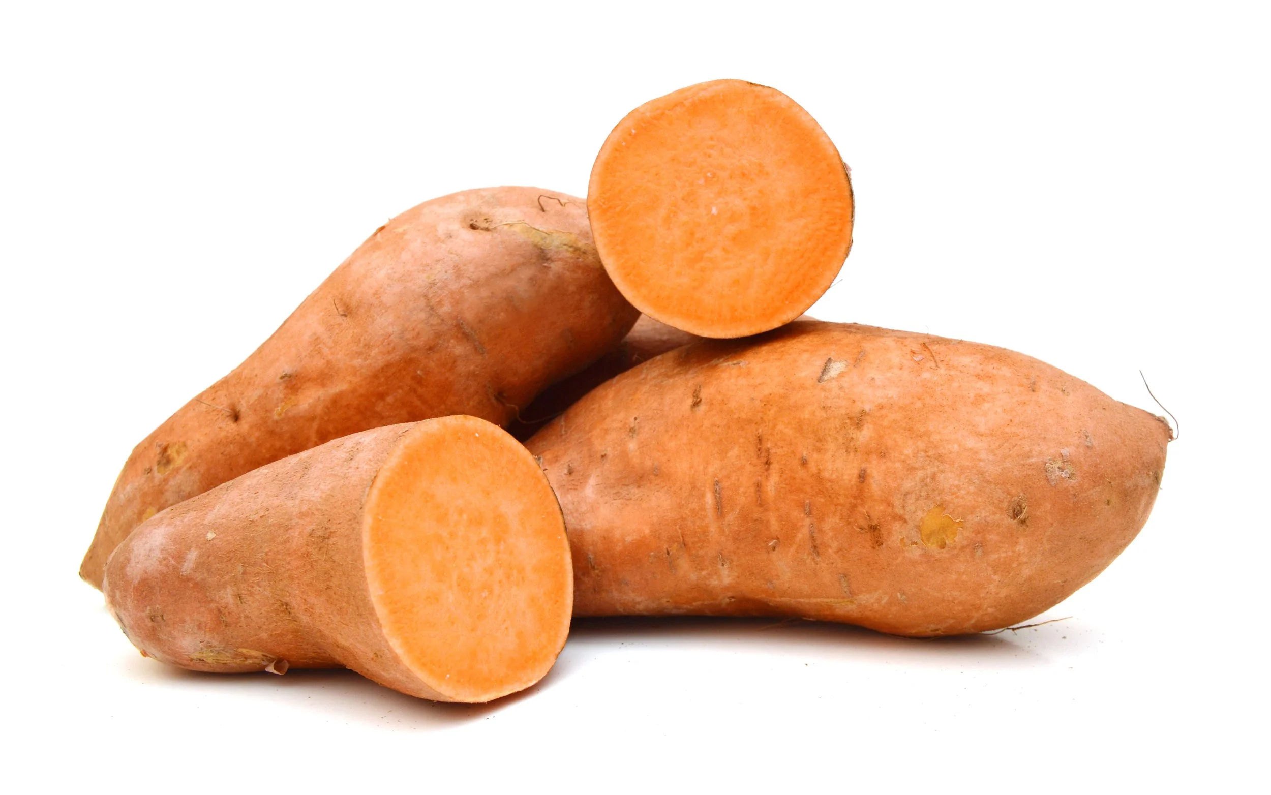 Three sweet potatoes, two whole and one sliced in half, on a white background.
