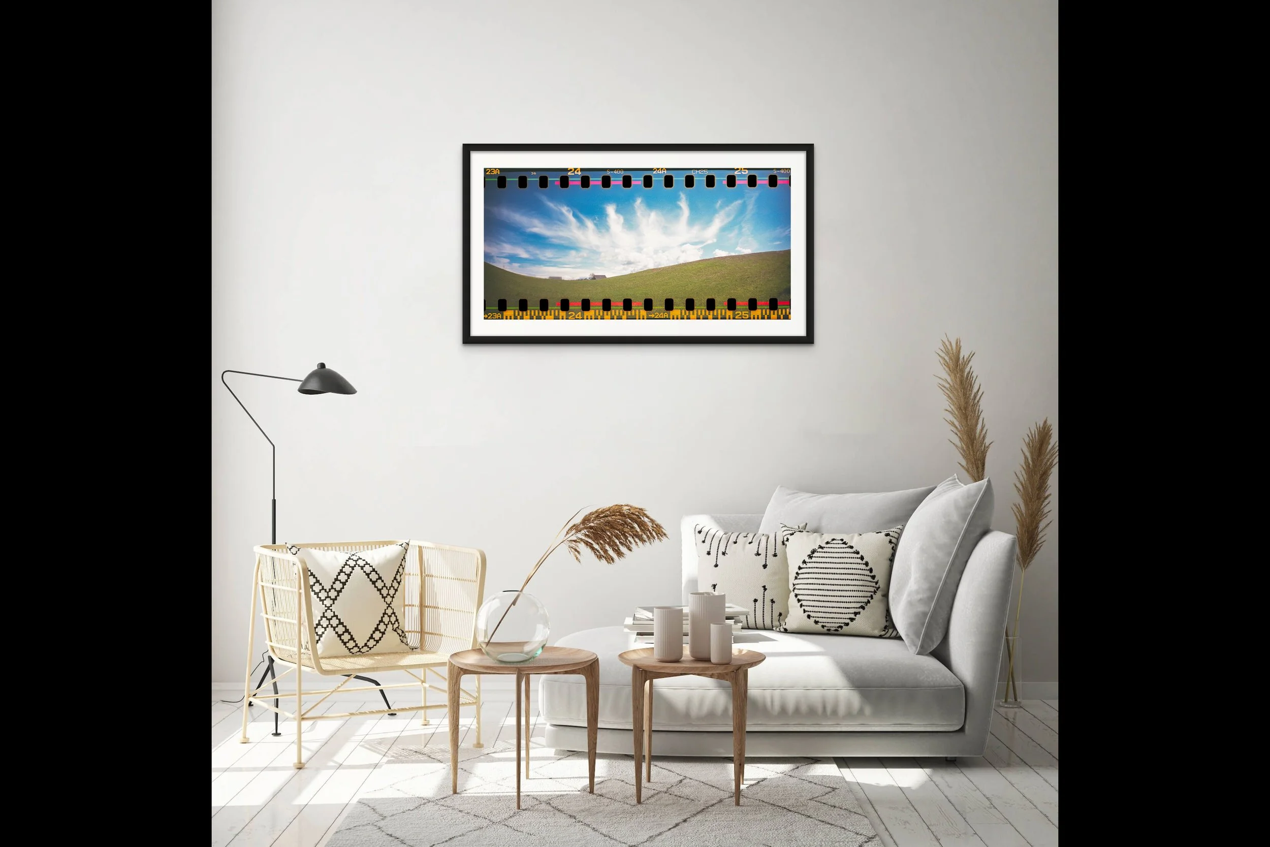 A photo of a rolling hill in the summer on block island adorns the wall of a living room