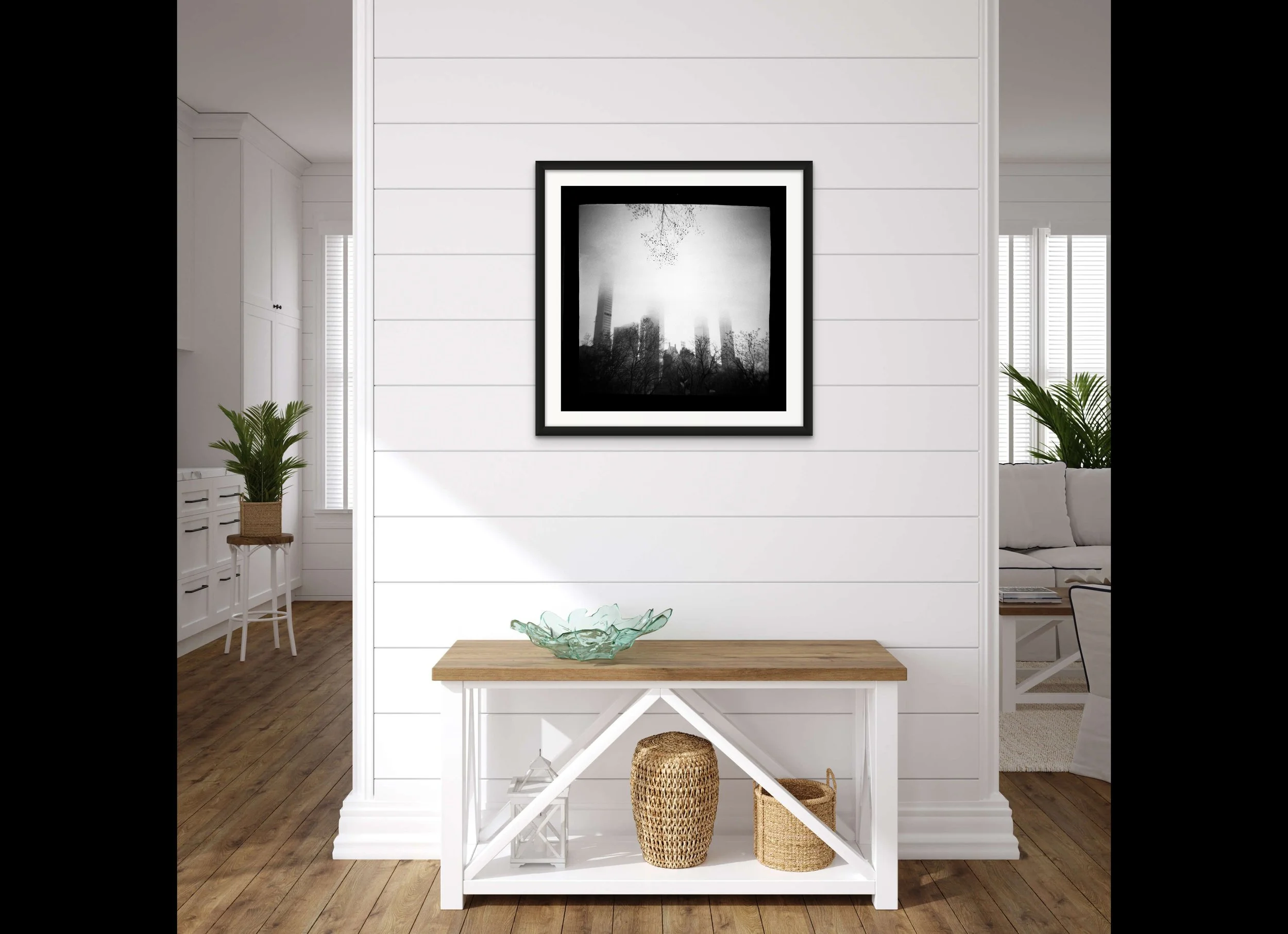 a framed photograph of skyscrapers of NYC in the fog