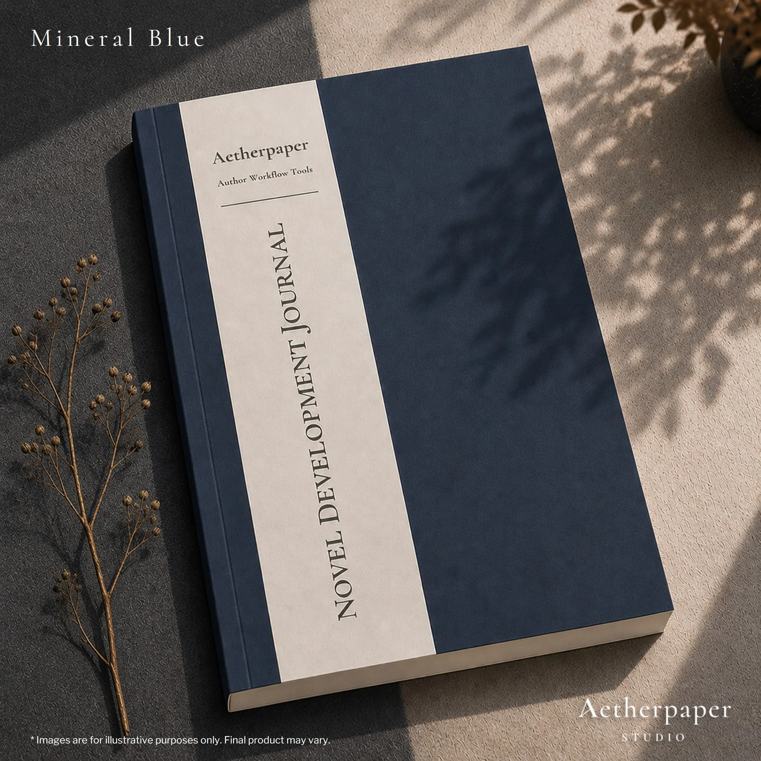 A dark blue hardcover journal with a white label that reads 'Aetherpaper Author Workflow Tools' and the words 'JOURNAL' printed vertically on the side. The journal is placed on a textured surface with a small dried plant branch and a plant in a black pot nearby. Sunlight casts shadows across the scene.
