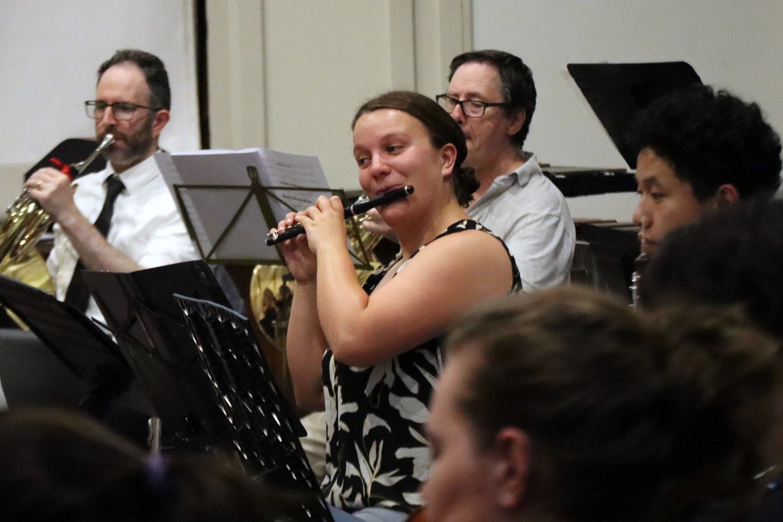 Monash University Flute Ensemble in 2018, pictued with instruments and colourful scarves.