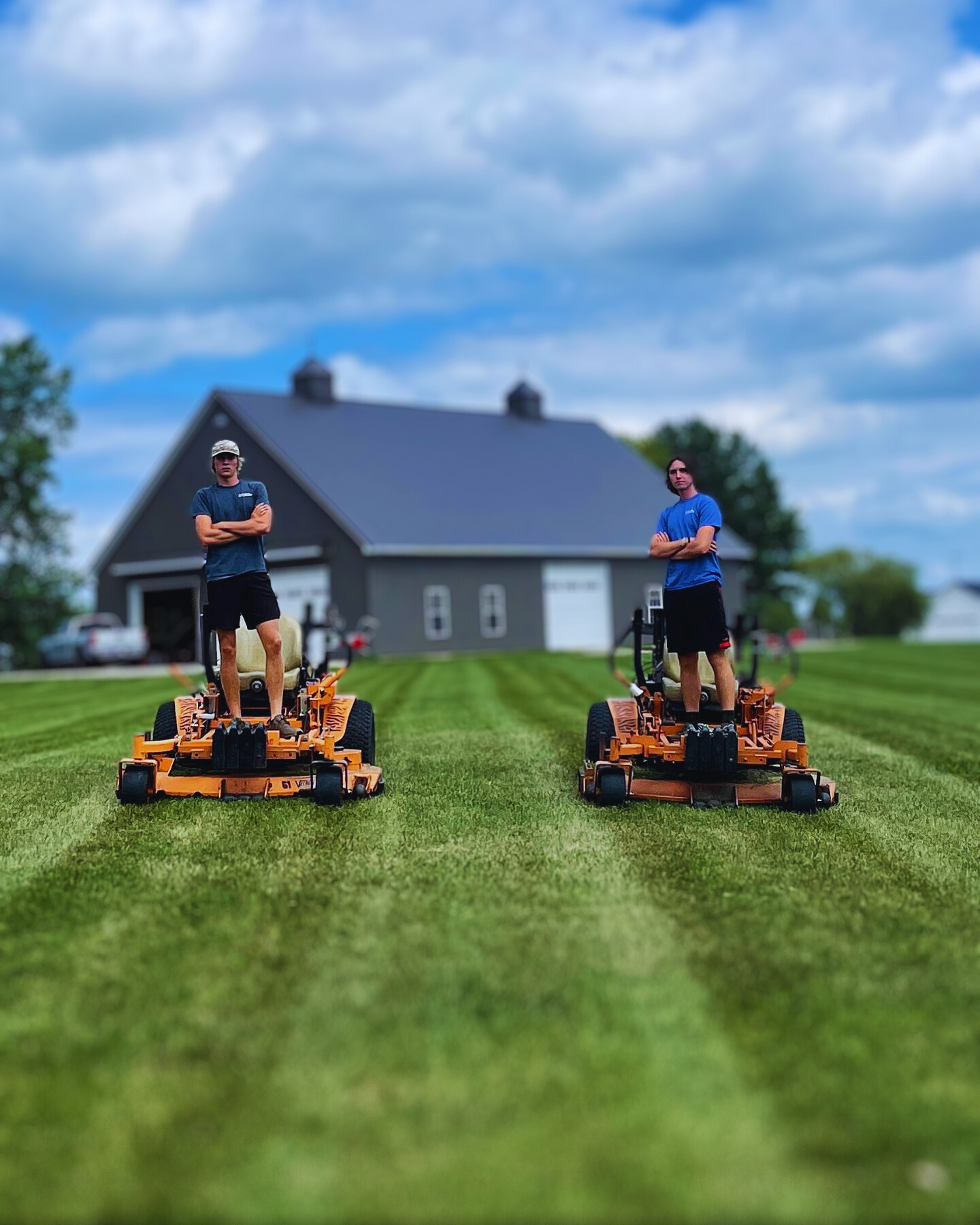 Two guys on a lawnmower.png