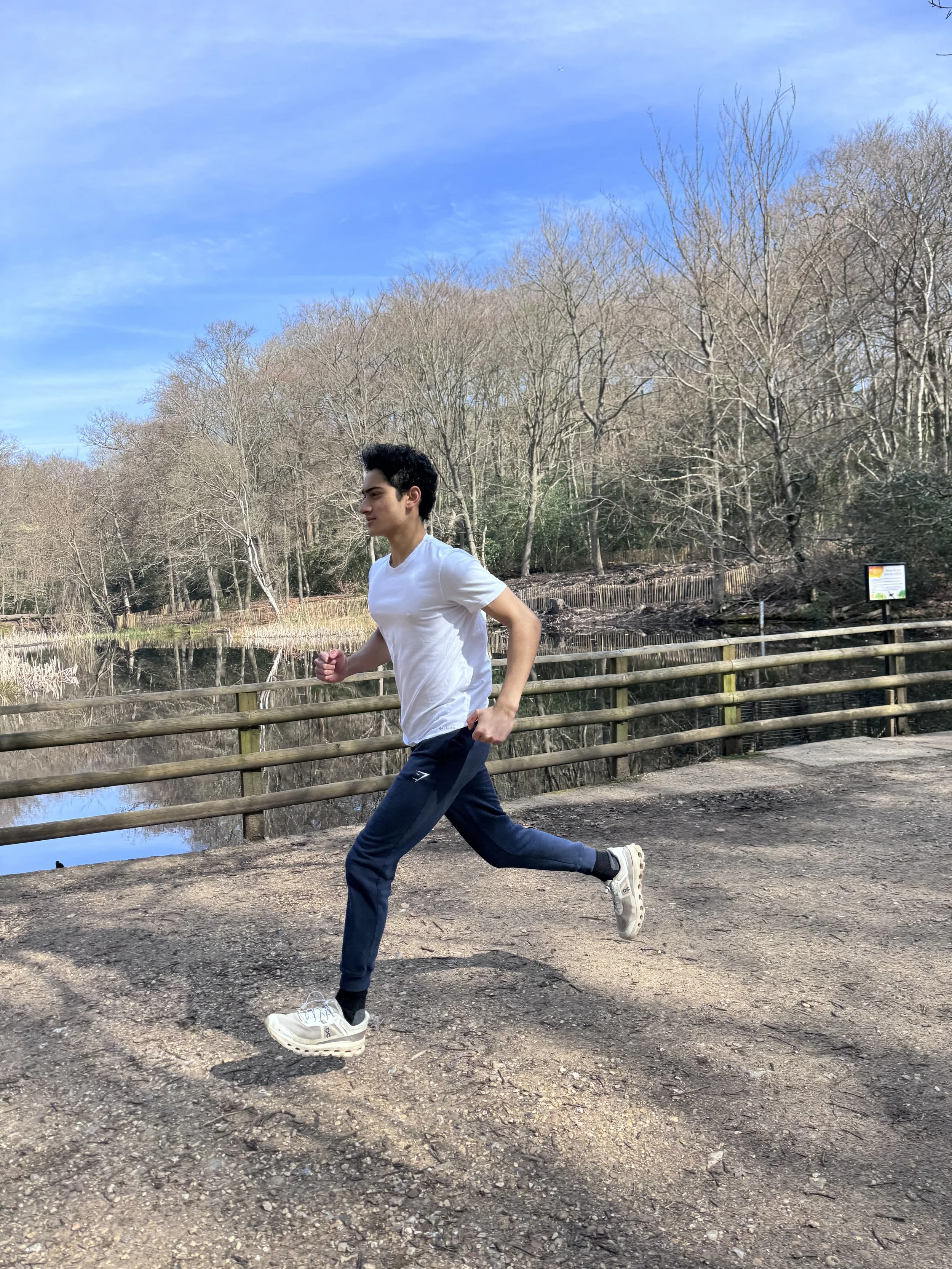 Young male athlete running and the knee