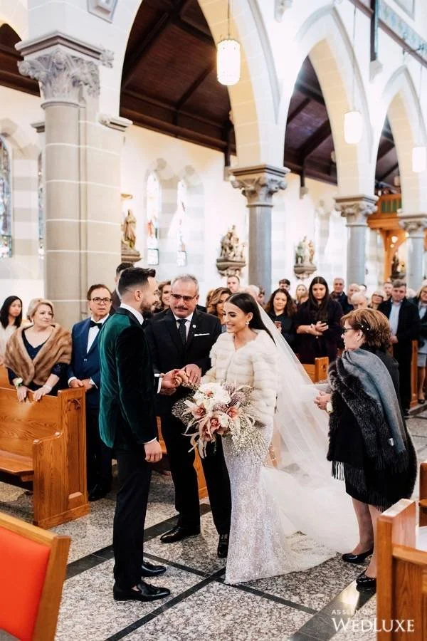 Bride walks down a Toronto Church aisle and is handed over to the groom.