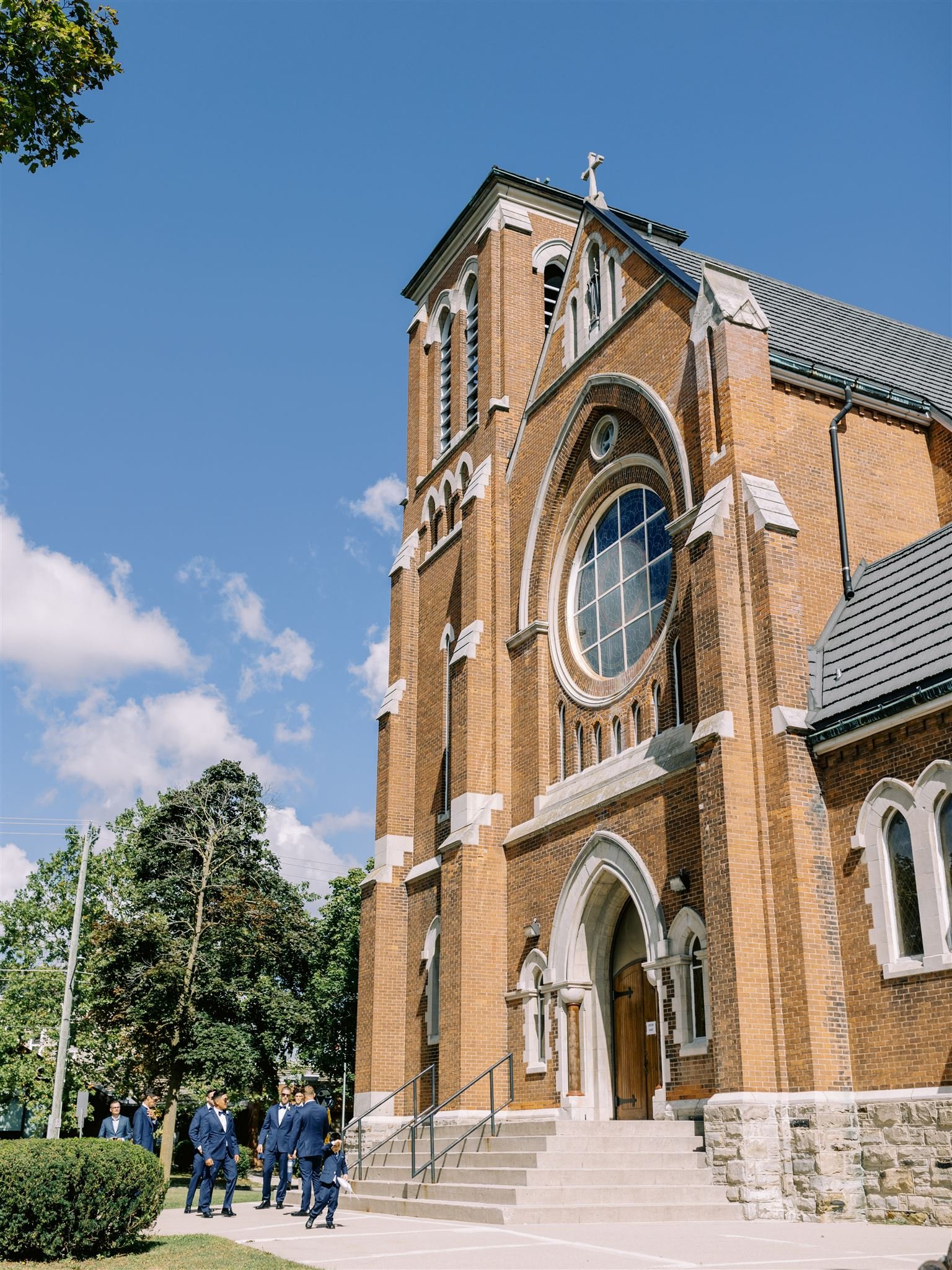An exterior image of a Church in Cambridge, Ontario while the groomsmen await their guests to arrive.