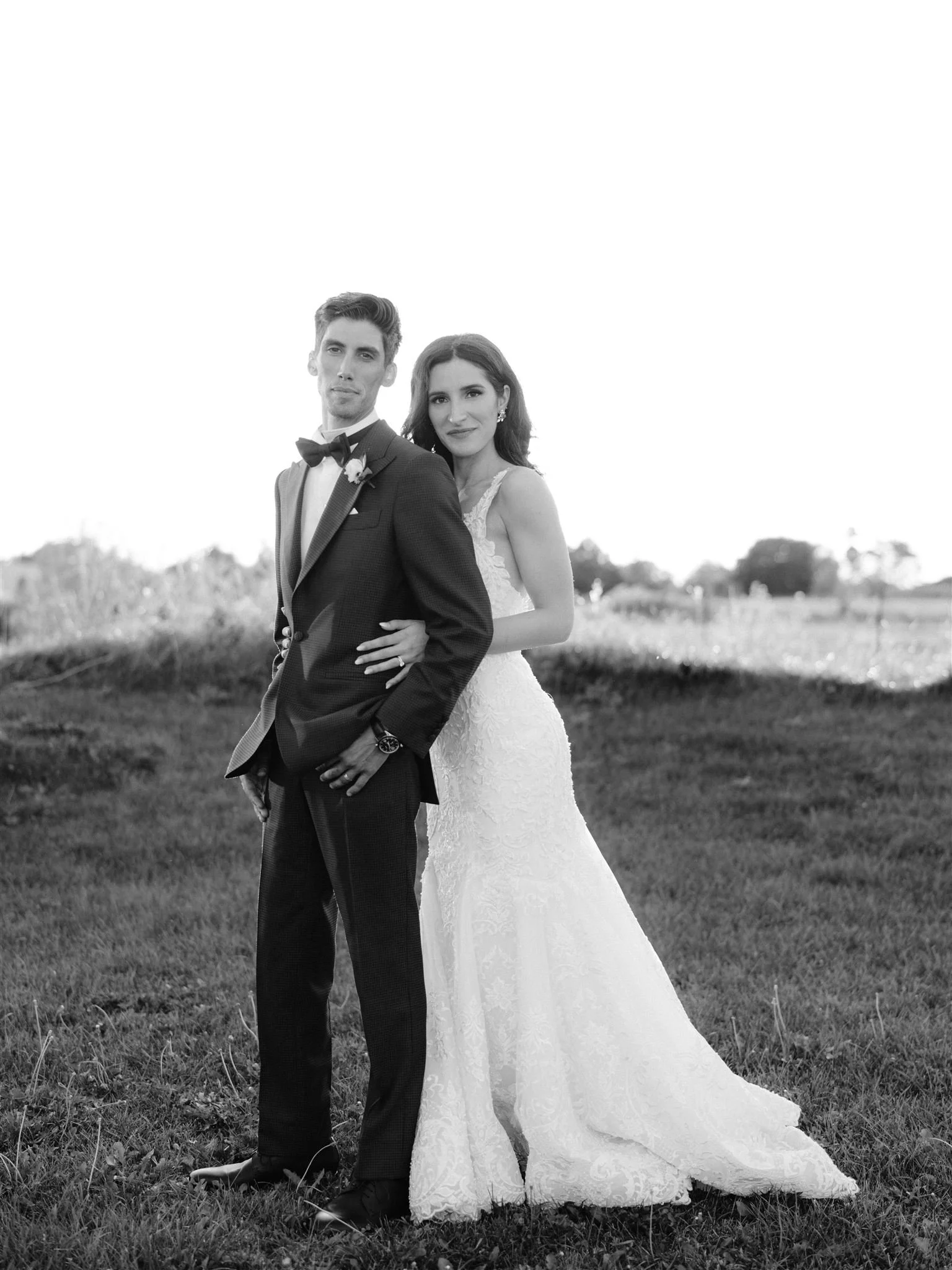 A classic black and white image of the bride and groom posing into the sunset during the creative park photo session in Mississauga, Ontario.