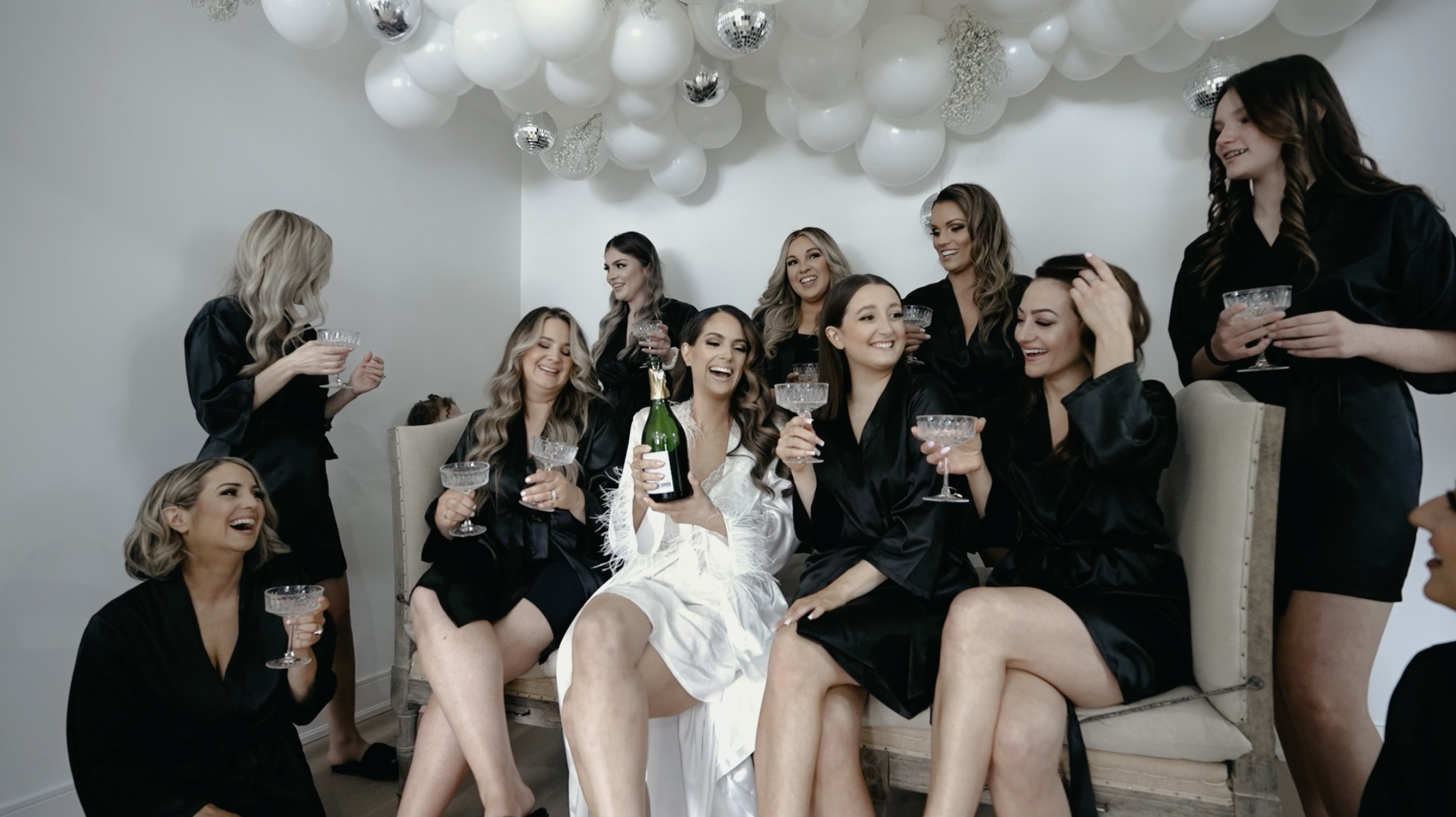 The bridesmaids celebrating with champagne.