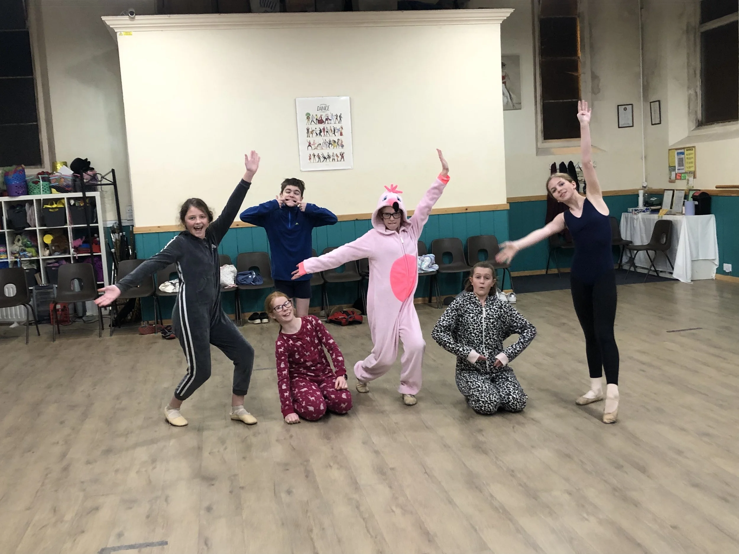Students at Just Dance in fun animal onesies during a playful studio session, highlighting their creativity and teamwork in a relaxed atmosphere.