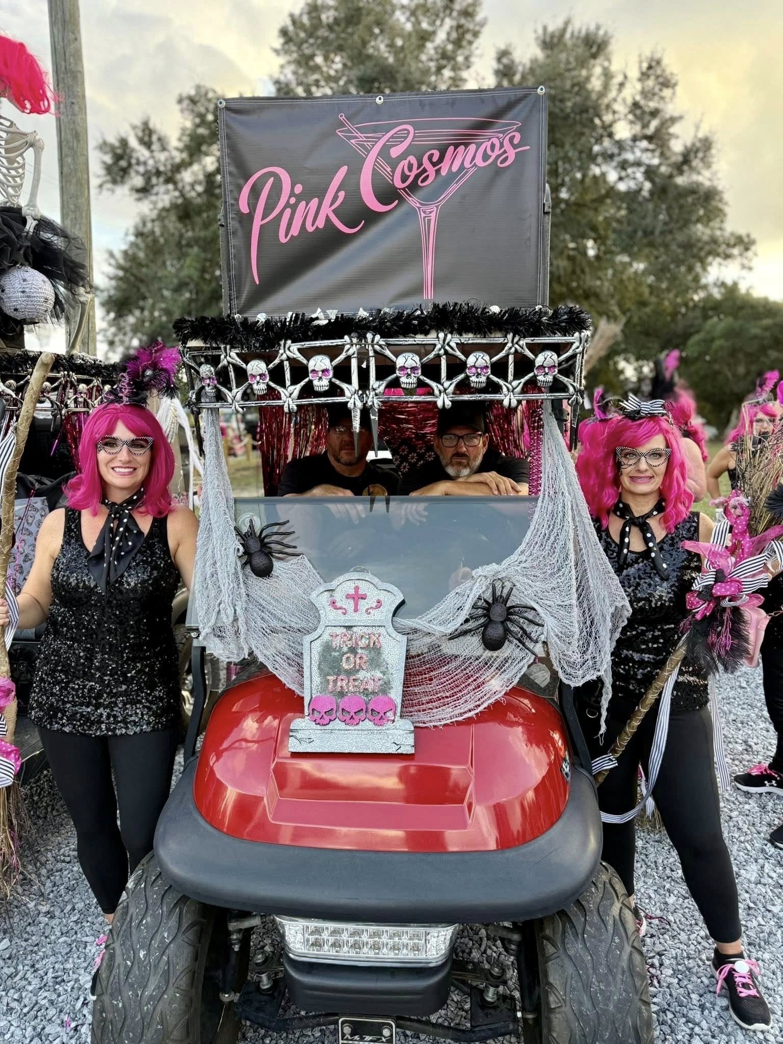 A decorated golf cart with a pink and black 