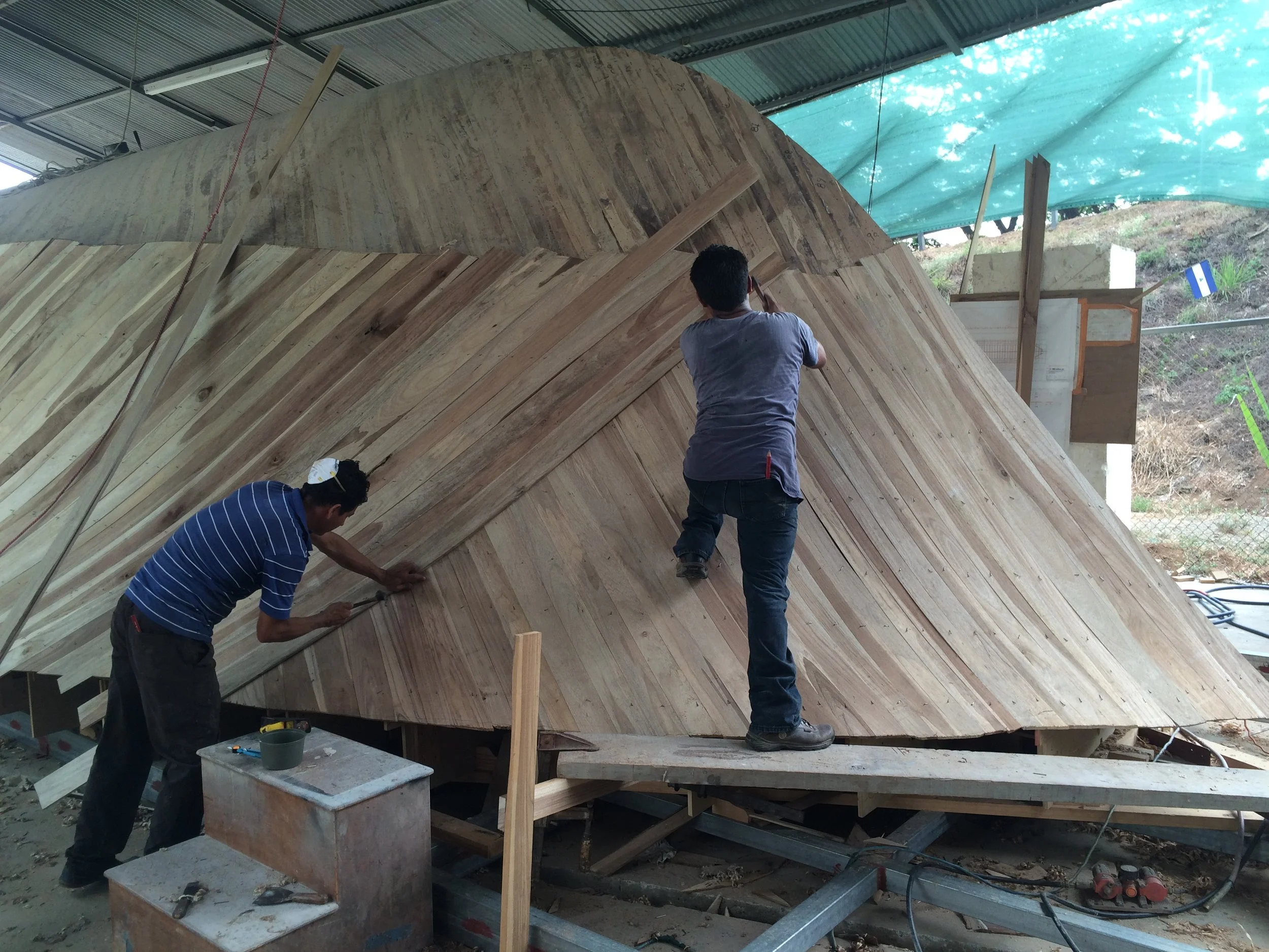 men building boat