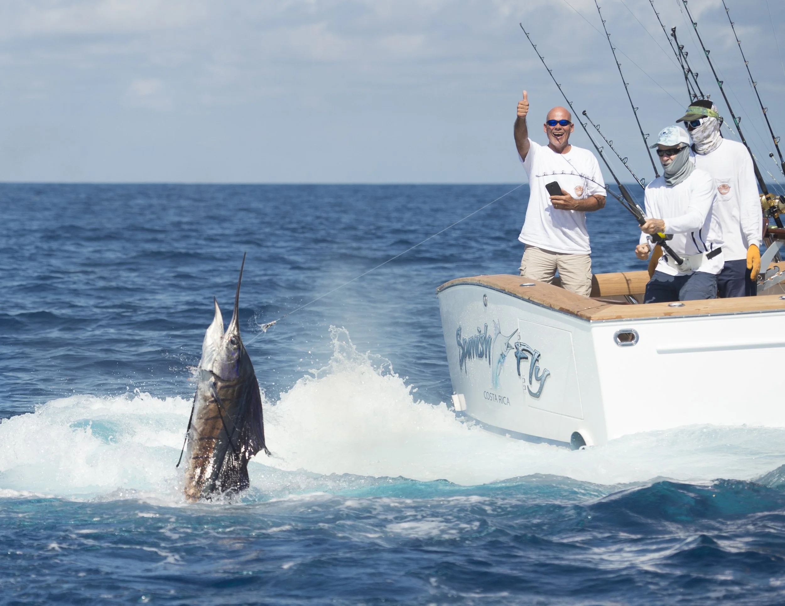 man giving thumbs up after catching large fish