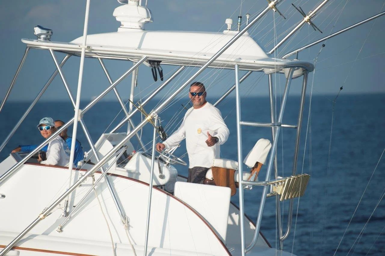 man giving thumbs up while driving charter boat