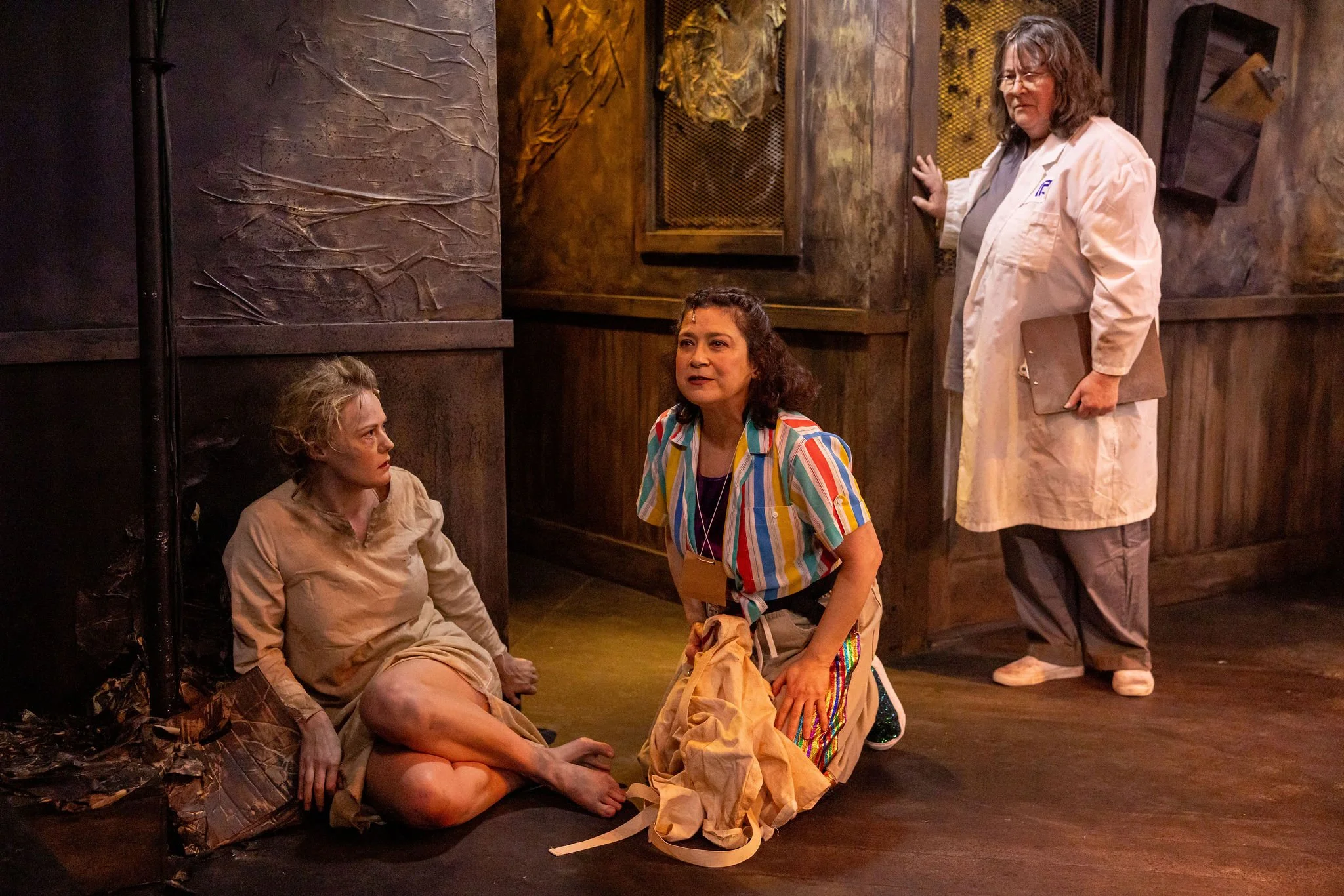 Talena Lane as Aldonza, Cynthia Dario-Good as Don Quixote, and Pat Haines-Ainsworth as the Governor  in MAN OF LA MANCHA at Reboot Theatre Company.