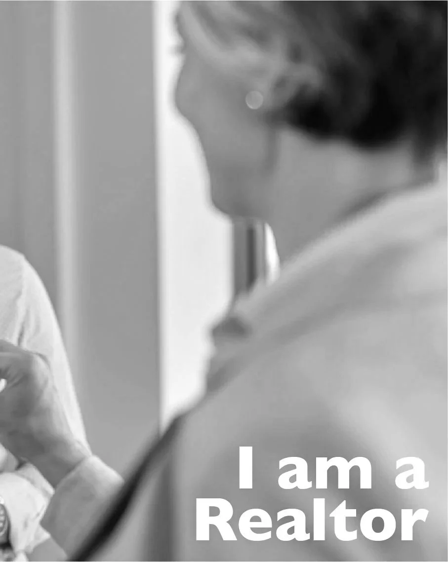 A black and white photo of a woman with short hair, wearing glasses, standing in profile. Text overlay reads, 'I am a Realtor.'