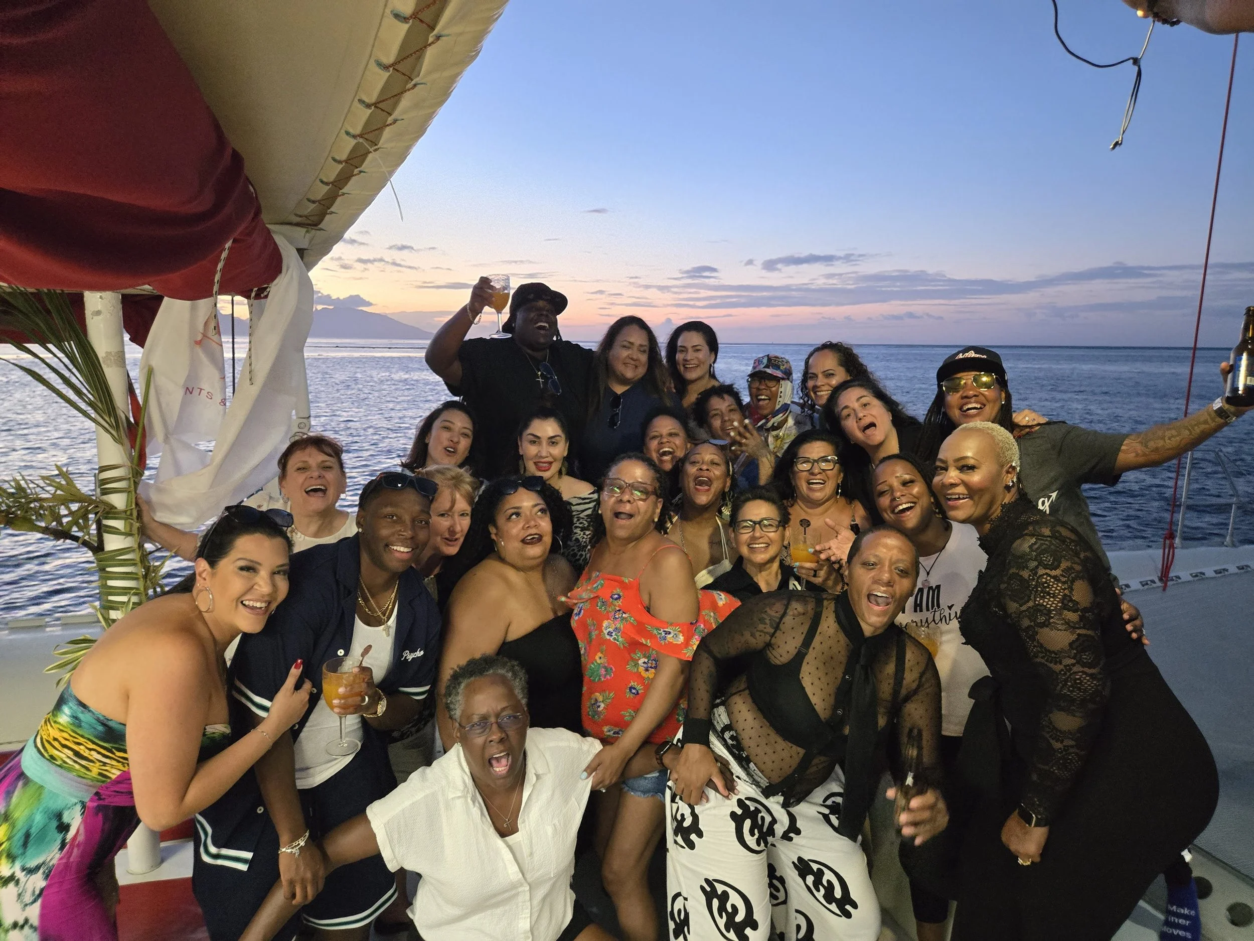 LGBTQ women's group toasting sunset on a catamaran in French Polynesia with Ladies Touch