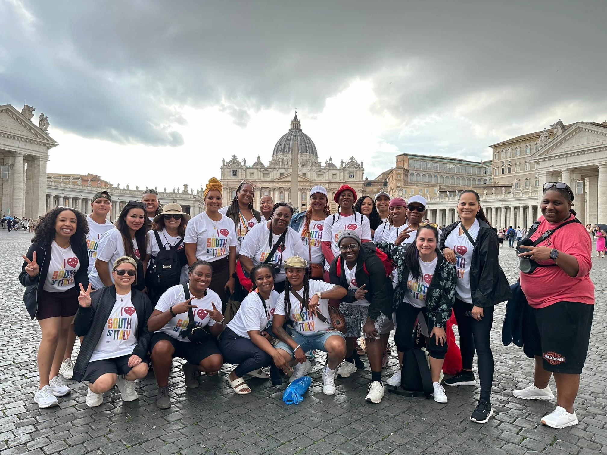 Lesbian group travelers in matching South of Italy shirts at St. Peter's Square, Vatican City