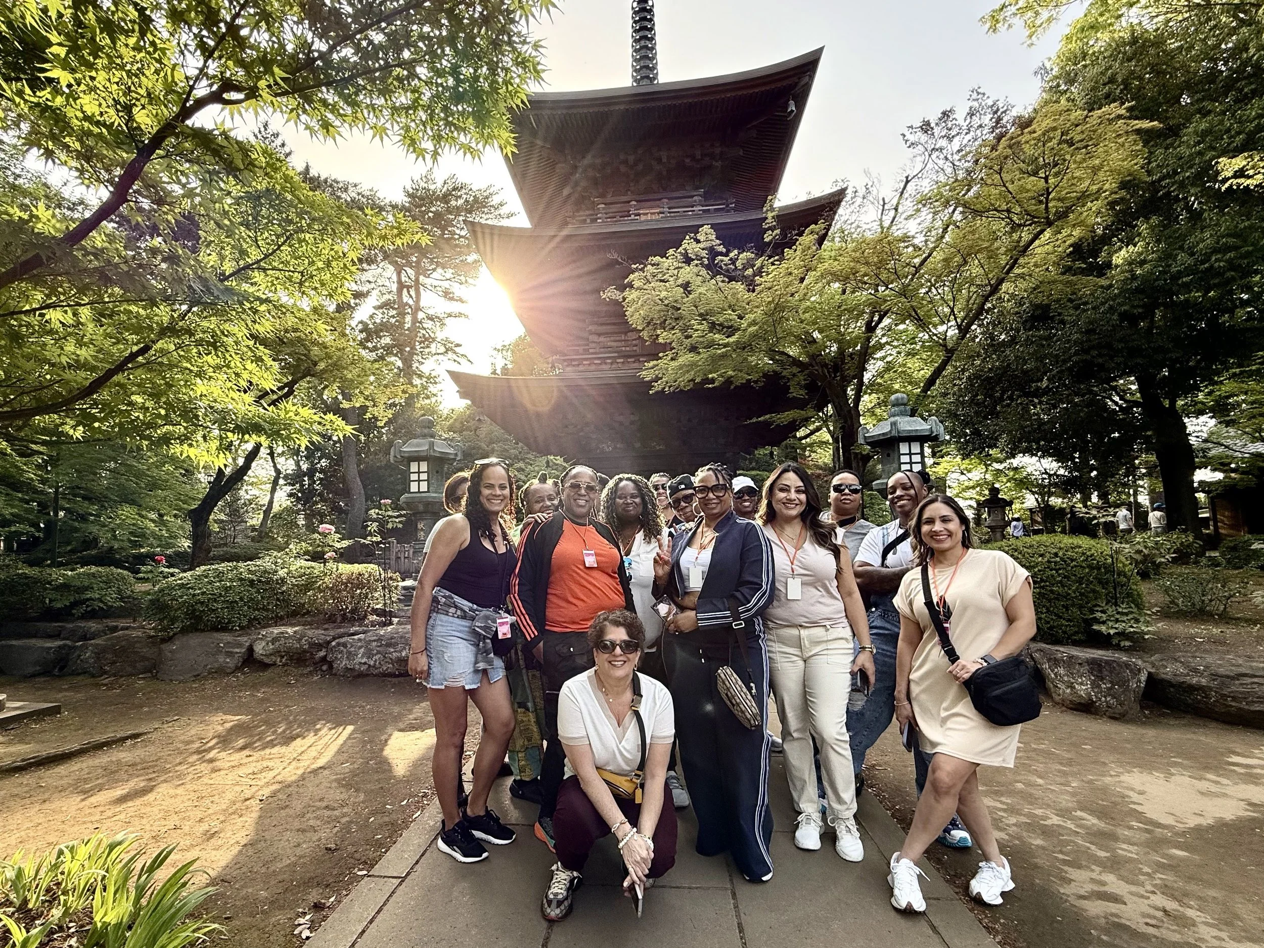 LGBTQ women's group travel in Japan posing at a traditional temple with Ladies Touch