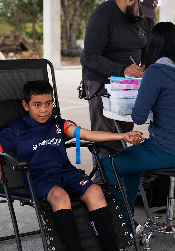 Serve Hope FC scholarship player receiving a preventive health check through Control Niño Sano in Honduras