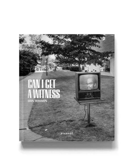 Cover of a limited edition book titled "Can I Get a Witness" by Don Hudson, featuring an outdoor scene with a vintage TV displaying Malcolm X, surrounded by trees and grass.