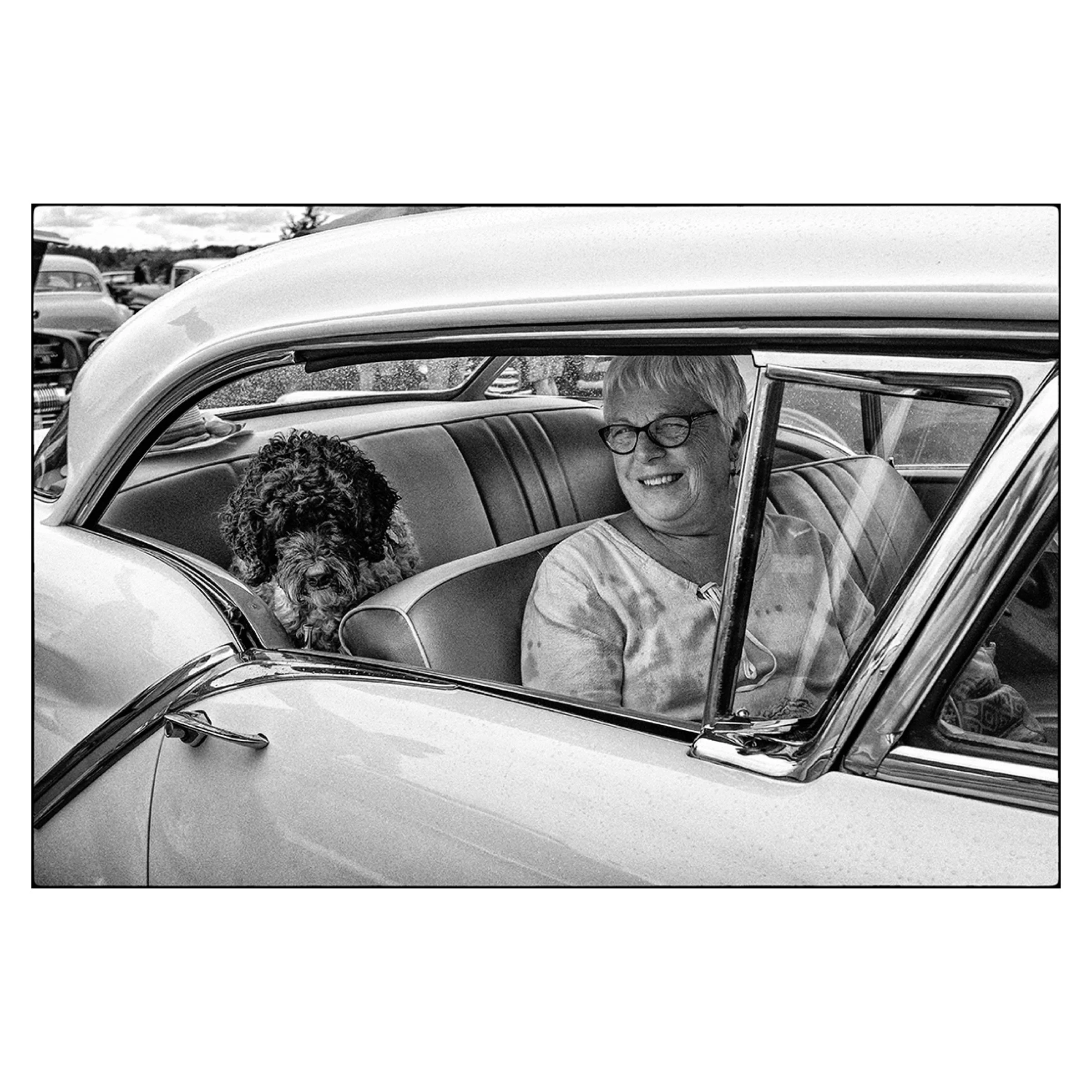A woman and her dog at an auto and airshow, Southern Ontario, 2024 © Dave Green