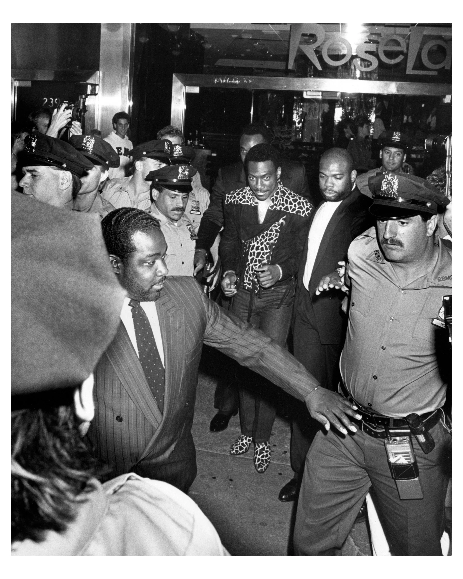 Eddie Murphy and Bodyguards at “Untouchables” Premiere, Loews Astor Plaza, NYC 1987 © Ron Galella