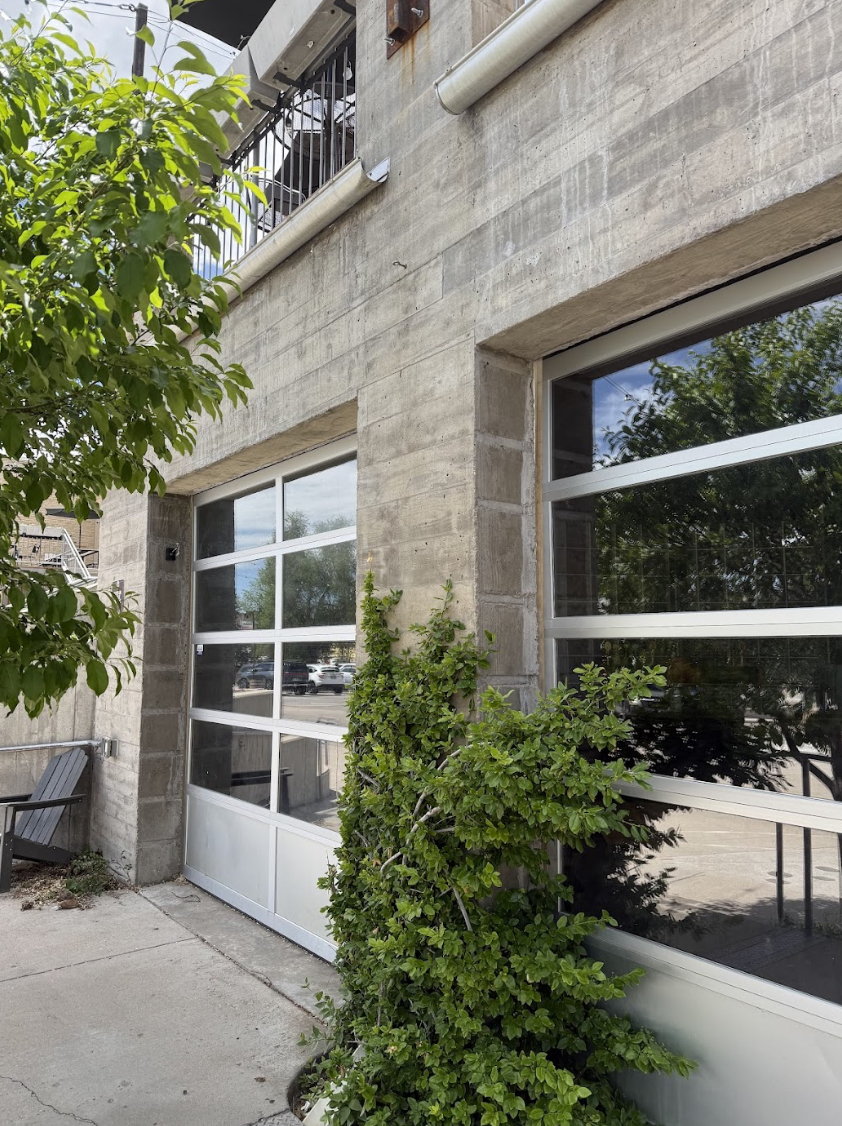 Garage doors open to the School Yard  showcasing the beauty of the outdoors in style of this high end bar feeling room. 