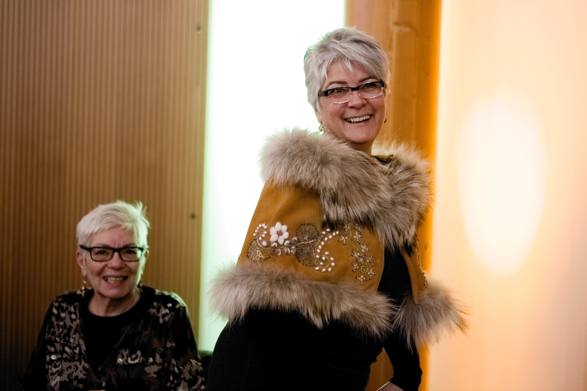 Event photograph by Christian Cuntz showing an image of two fur artisans created for Unfurled in 2018