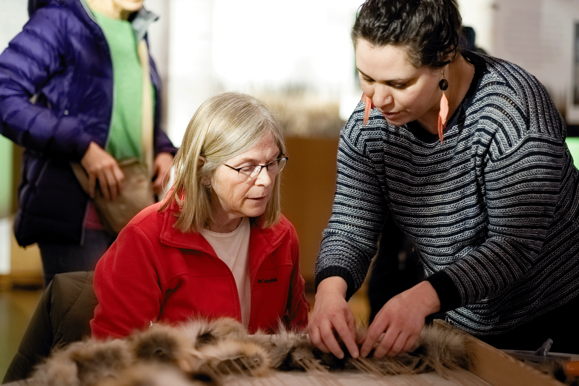 Event photograph by Christian Cuntz showing an image of two women crafting with fur created for Unfurled in 2018