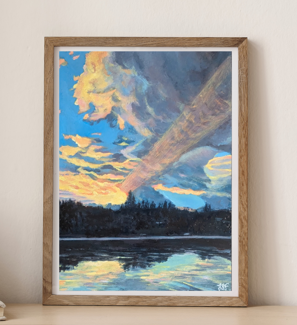 Framed print of a lake scene painted in acrylic. Golden light from the rising sun slants upward through dramatic clouds at sunrise of Bead Lake, which reflects its brilliance.